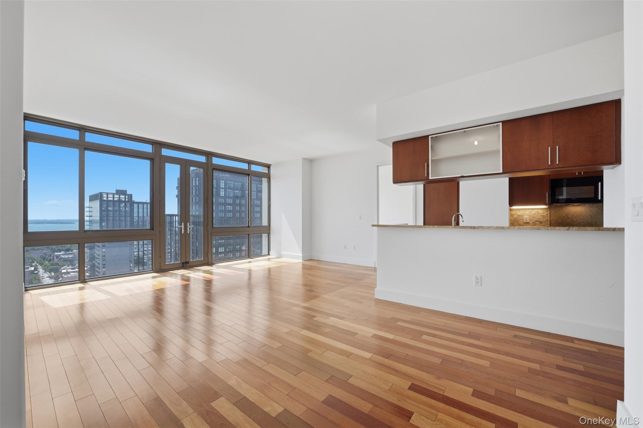 Perched on the 26th floor at Trump Plaza New Rochelle, this spacious t...