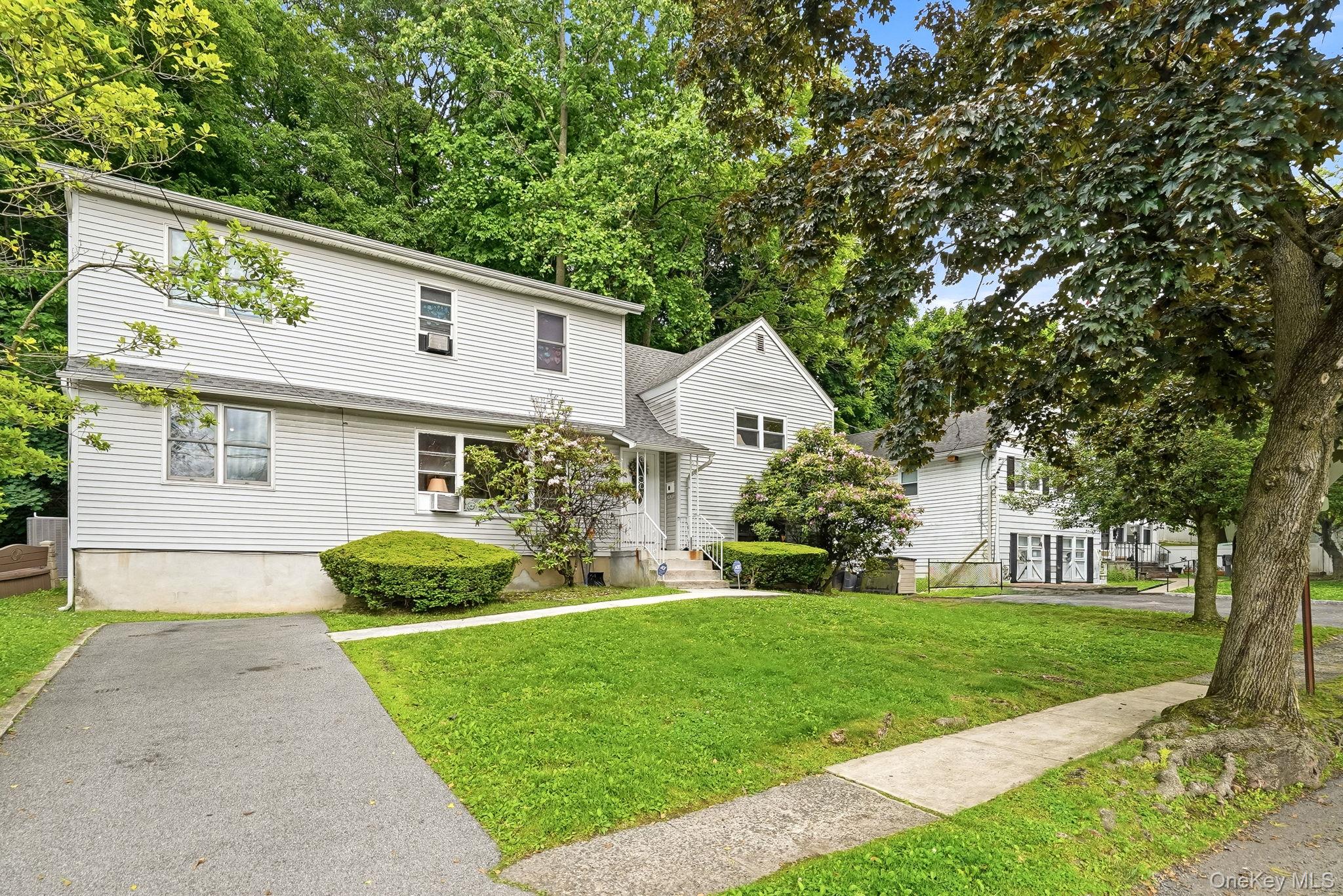 Nestled on a picturesque property, this expanded split-level home offe...