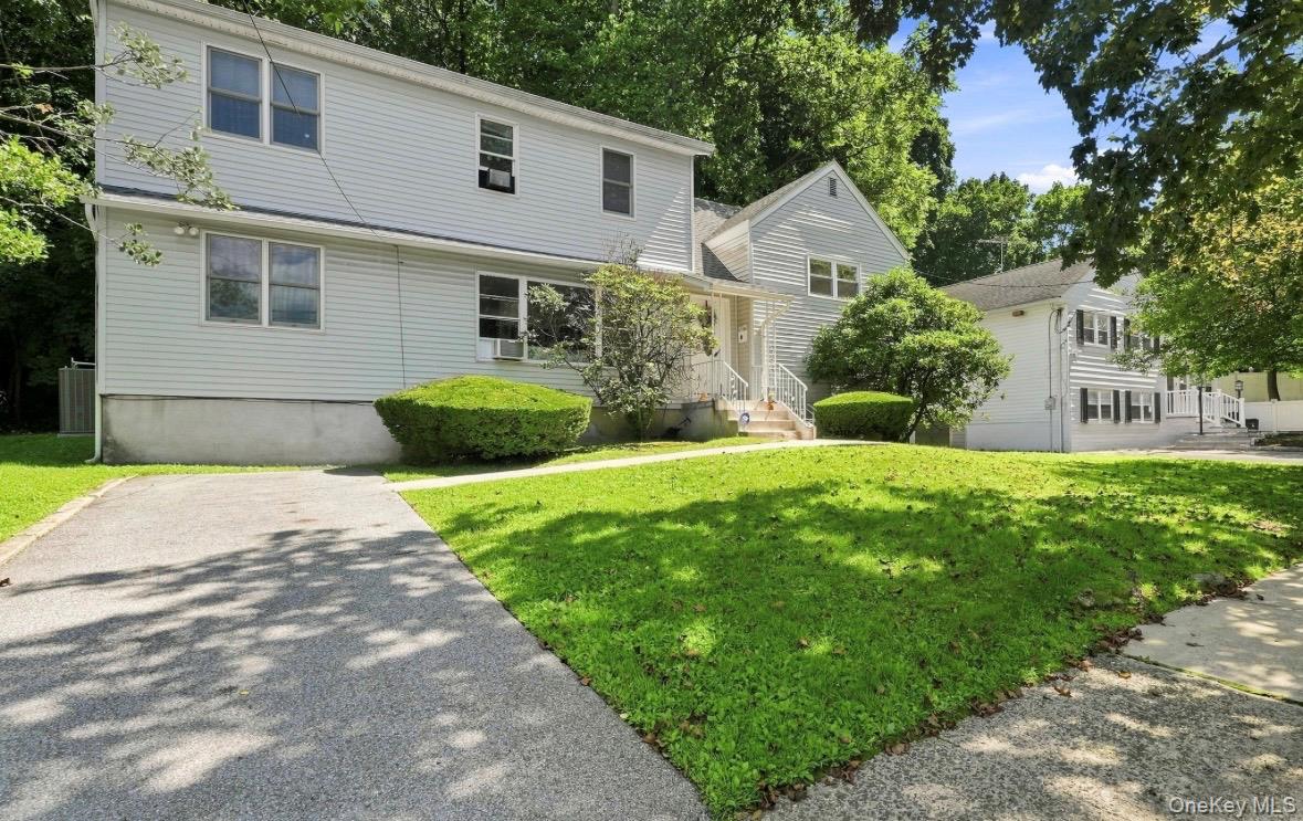 Nestled on a picturesque property, this expanded split-level home offe...