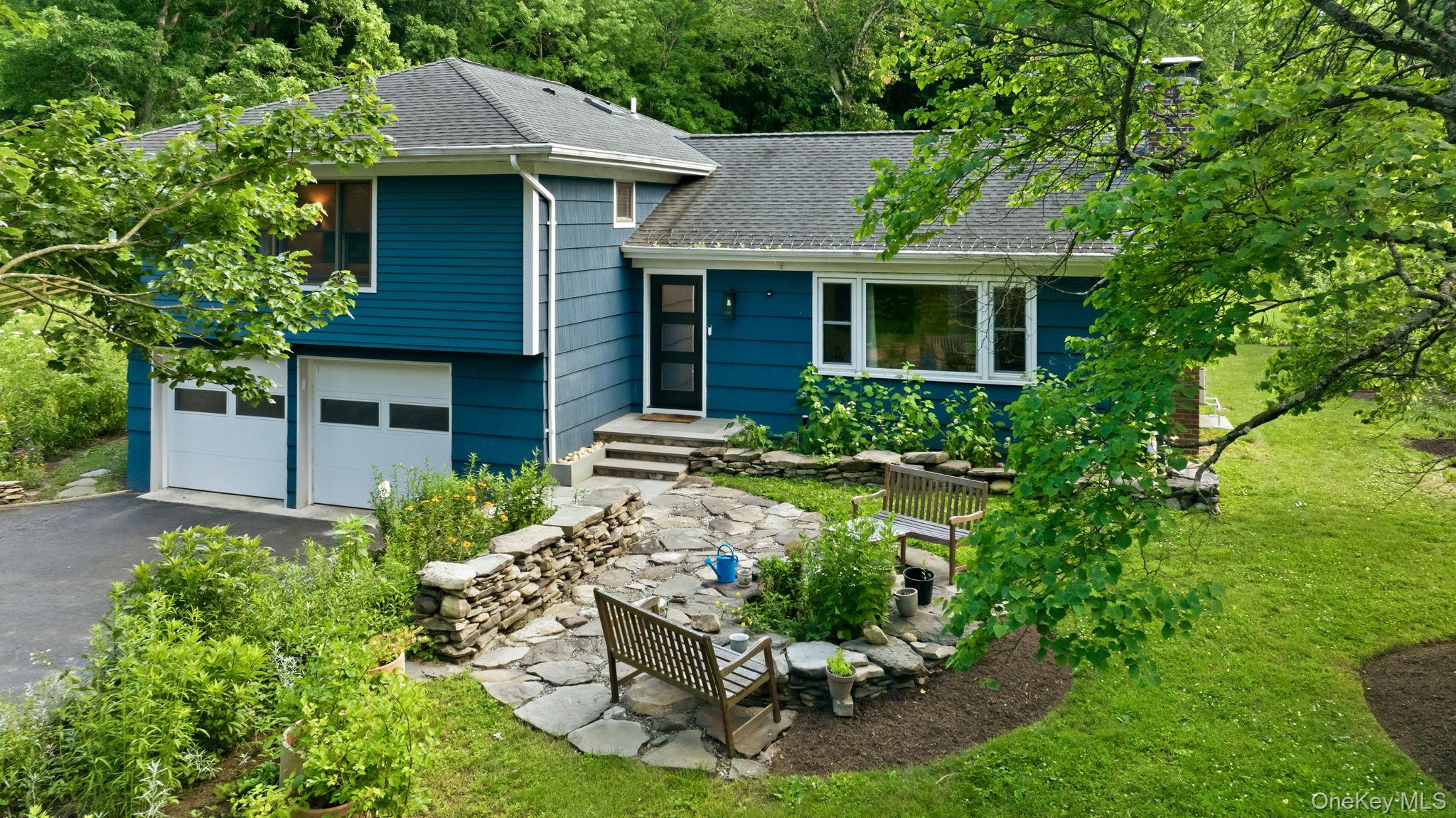 Katonah: Nestled on 2.1 private acres and directly abutting the 200 ac...