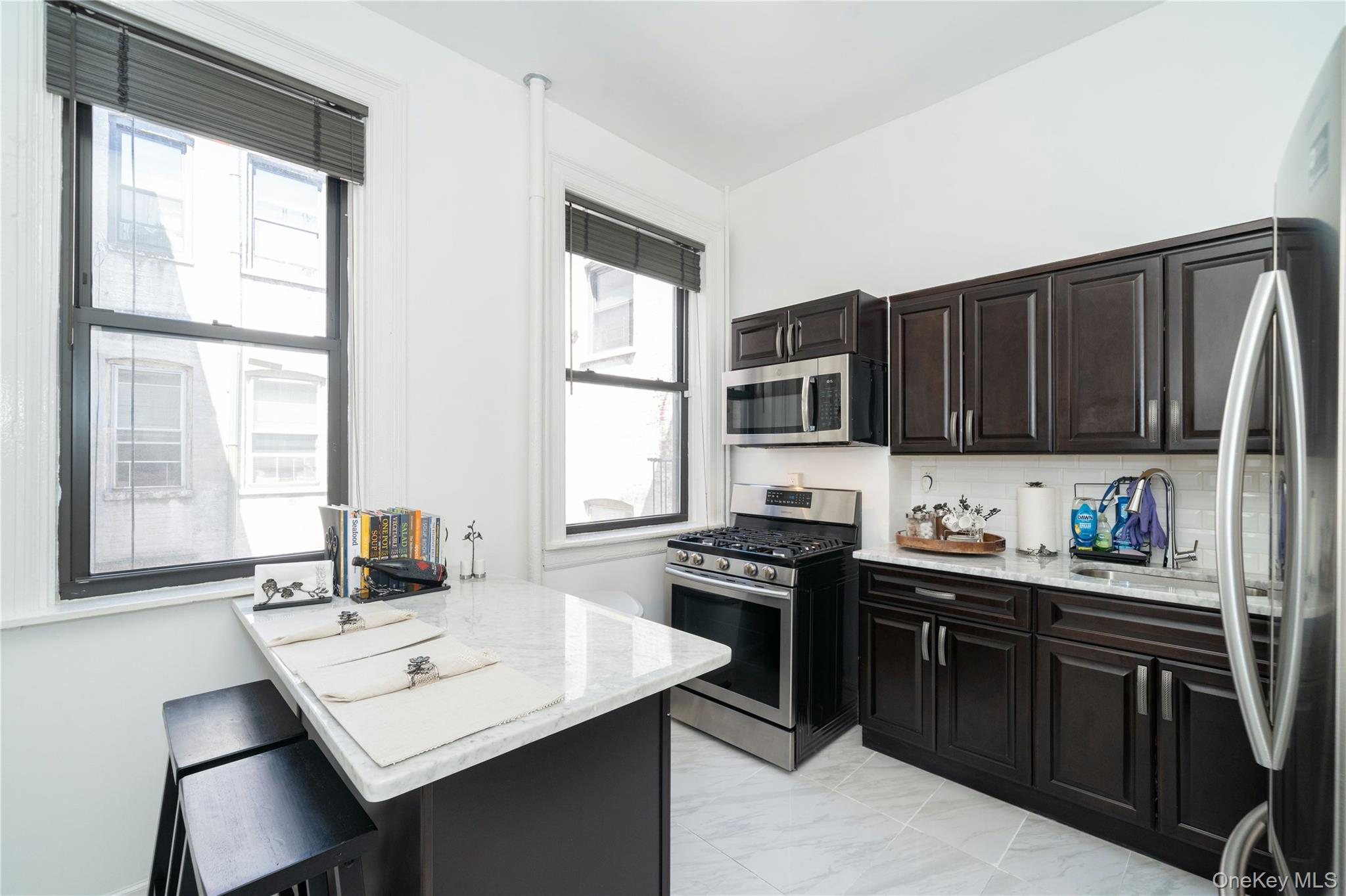 This beautiful three-bedroom residence feels like its own house, radia...