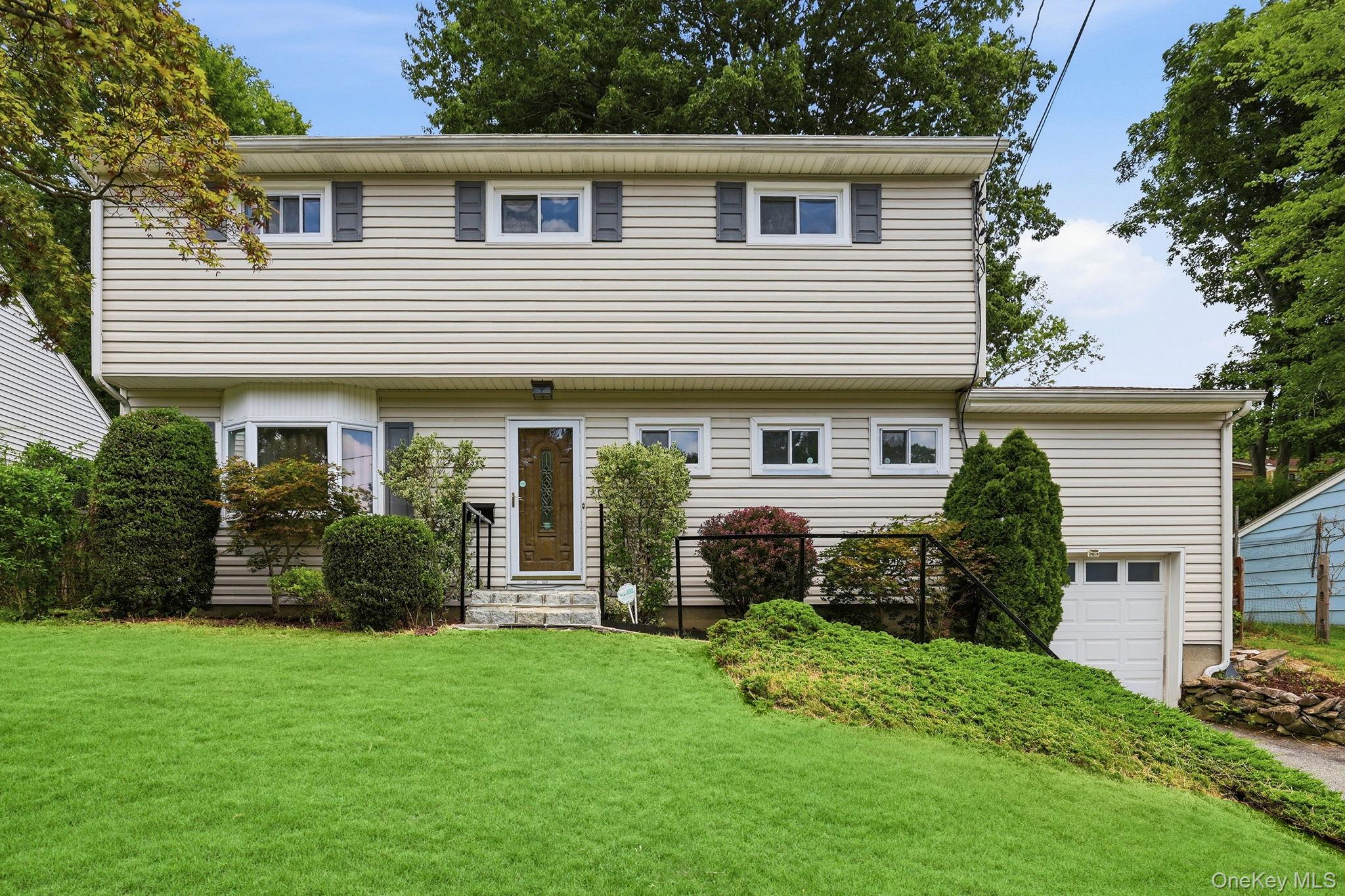 Welcome to this inviting split-level home, ideally located just minute...