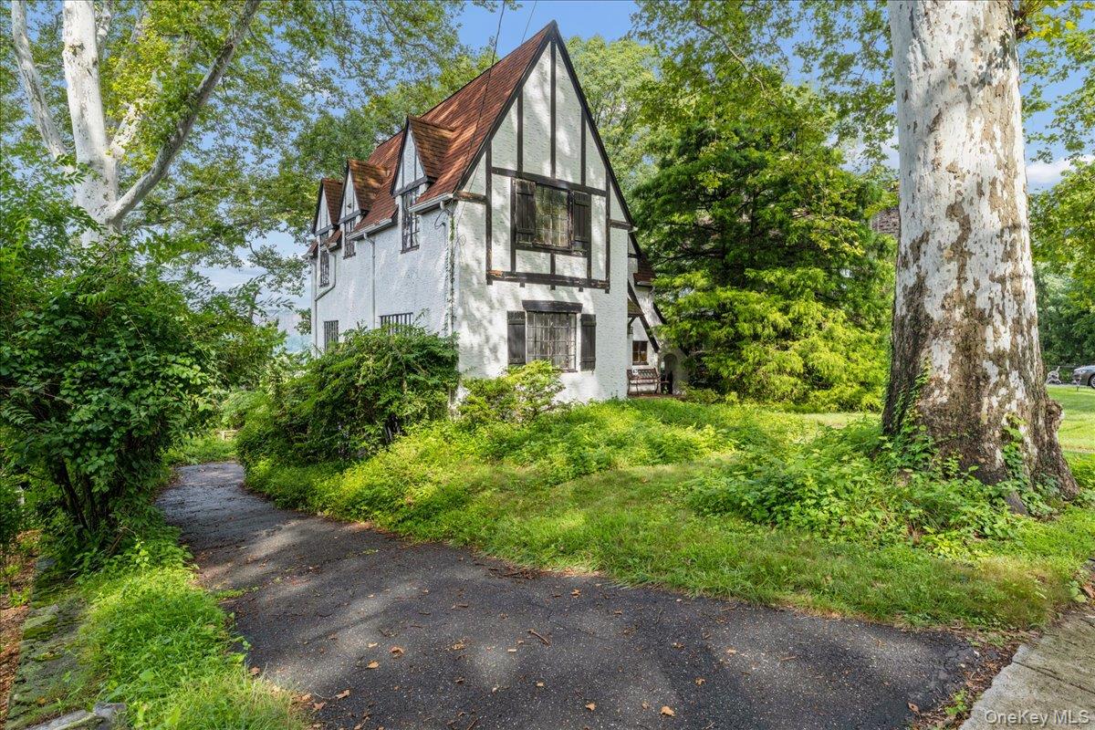 Perched on a tranquil dead-end street lined with majestic, mature syca...