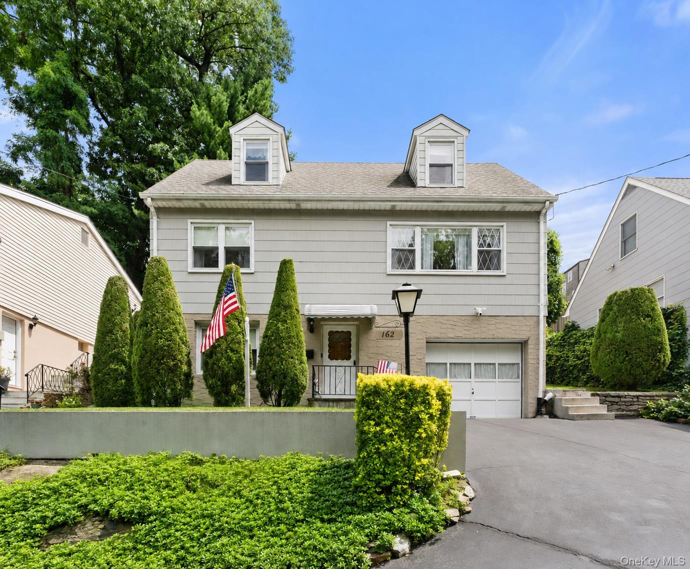 This Lincoln Park raised Cape Cod sits directly across from Tibbetts B...