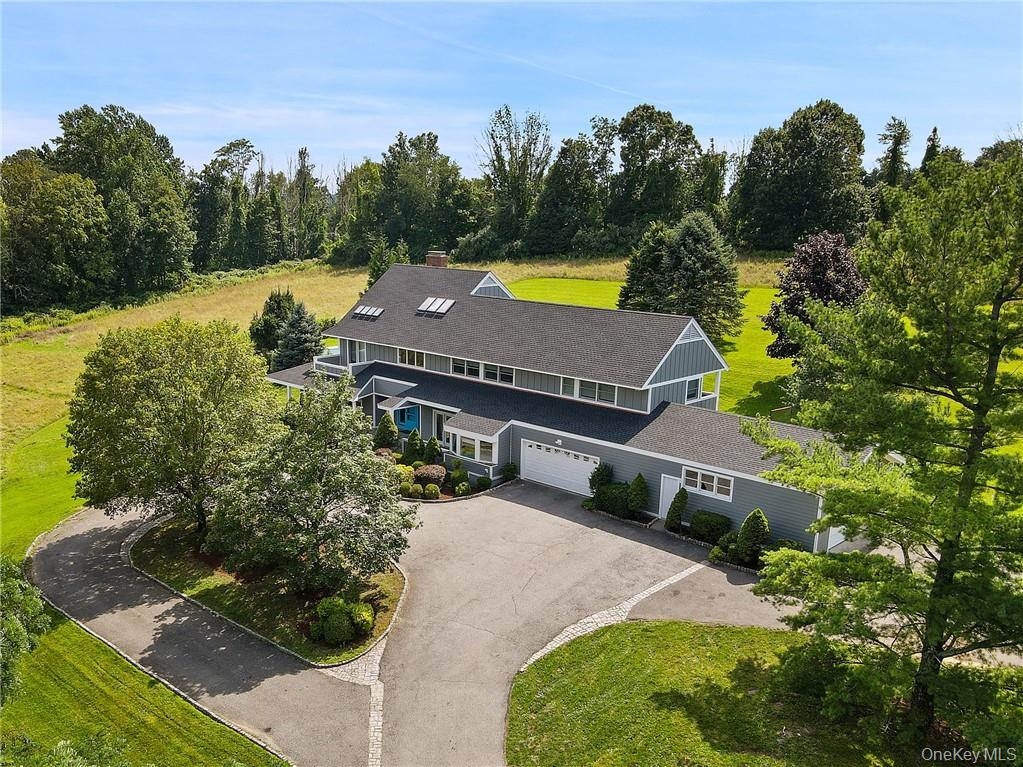 Sited with a commanding presence on eight plus acres of open meadows a...
