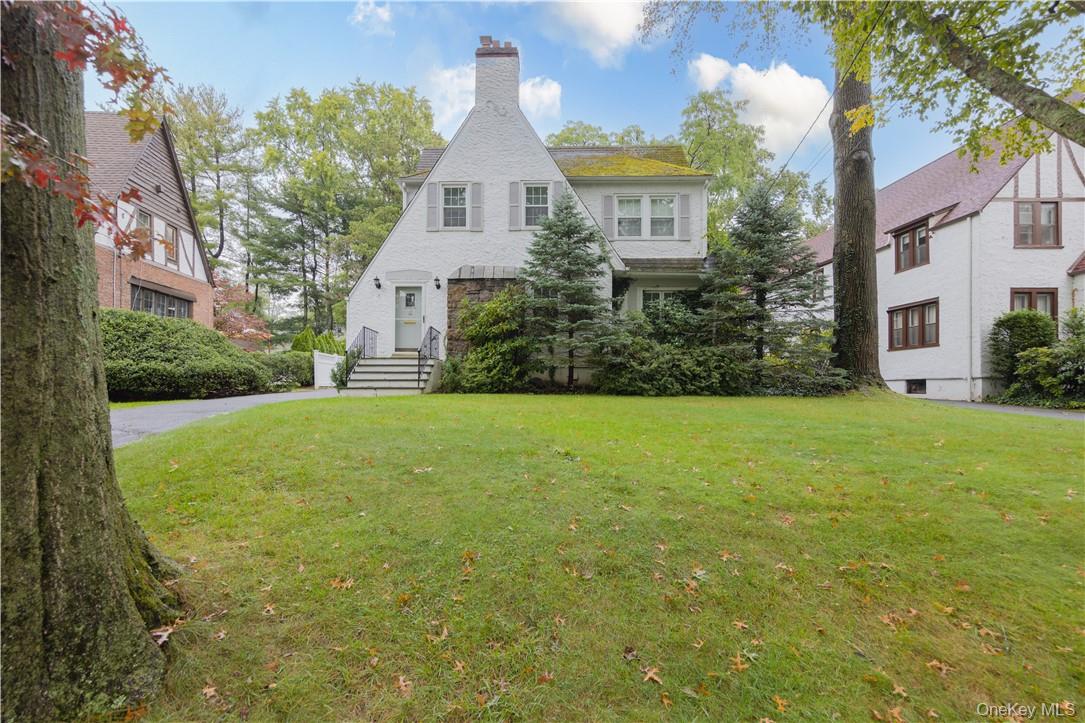 Move-in ready and brimming with charm! Handsome Tudor in convenient Qu...