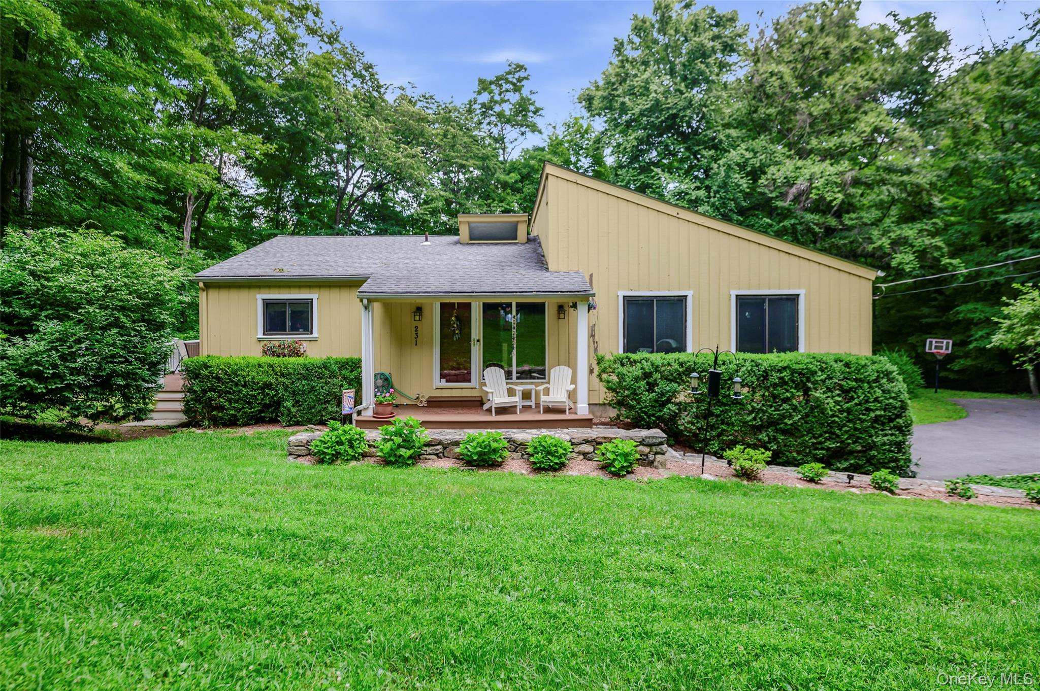 Nestled on two private, wooded acres, this beautifully updated 4-bedro...