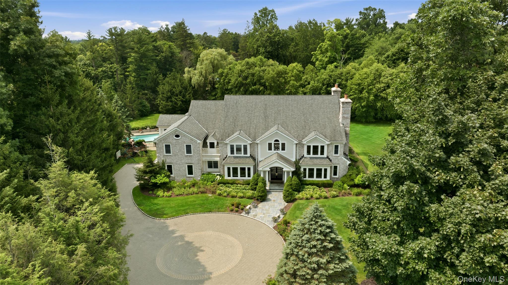 Beyond a tree-lined private drive and sweeping circular motor court li...
