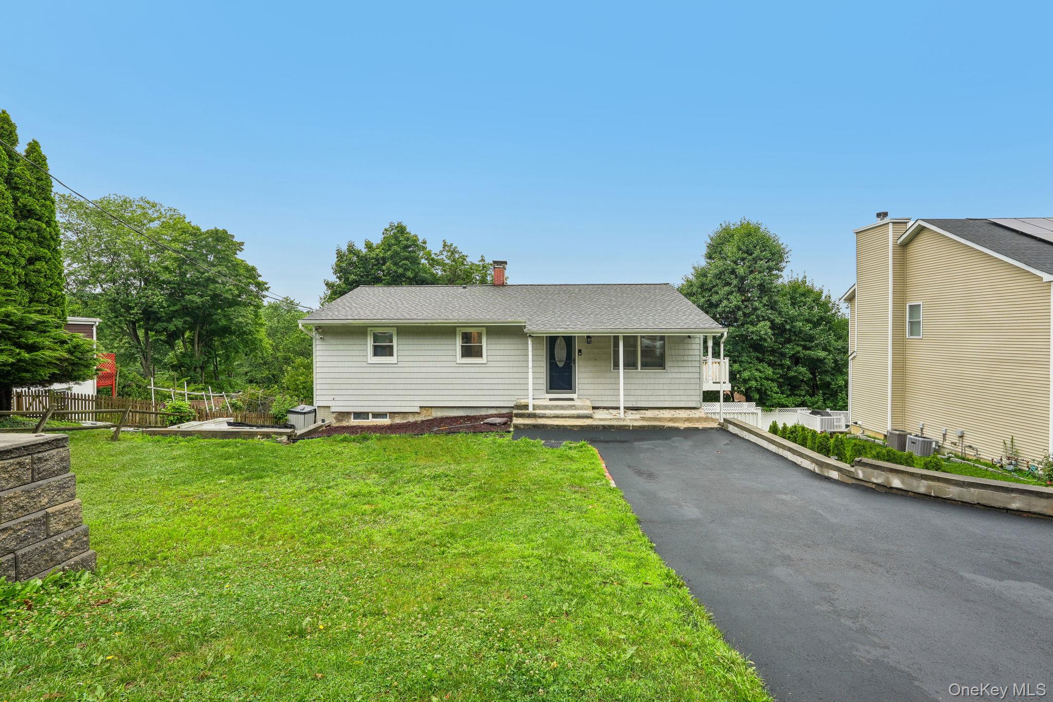 Charming and move in ready, this inviting three-bedroom ranch is nestl...