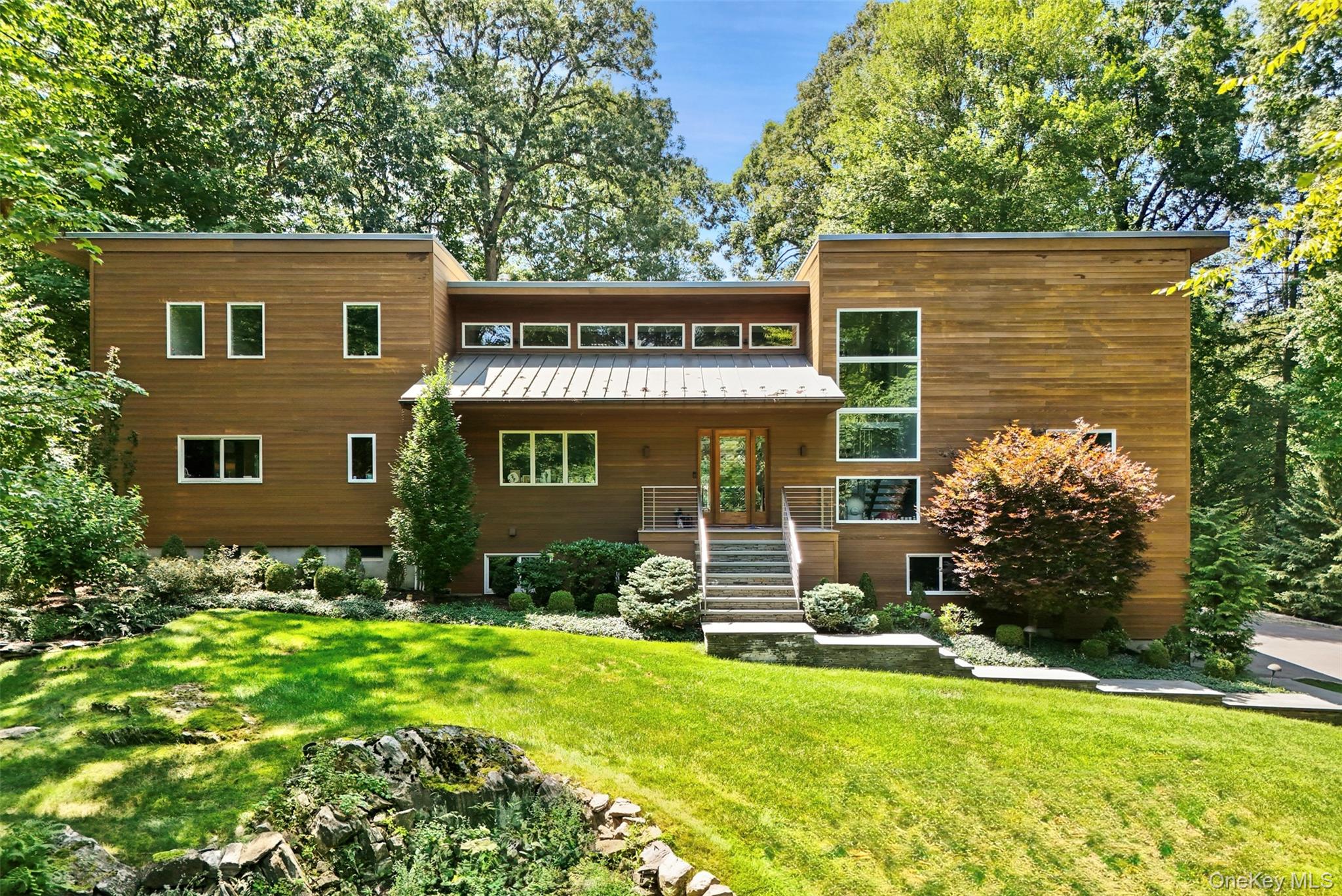 Set on more than four private acres at the end of a quiet Bedford Hill...