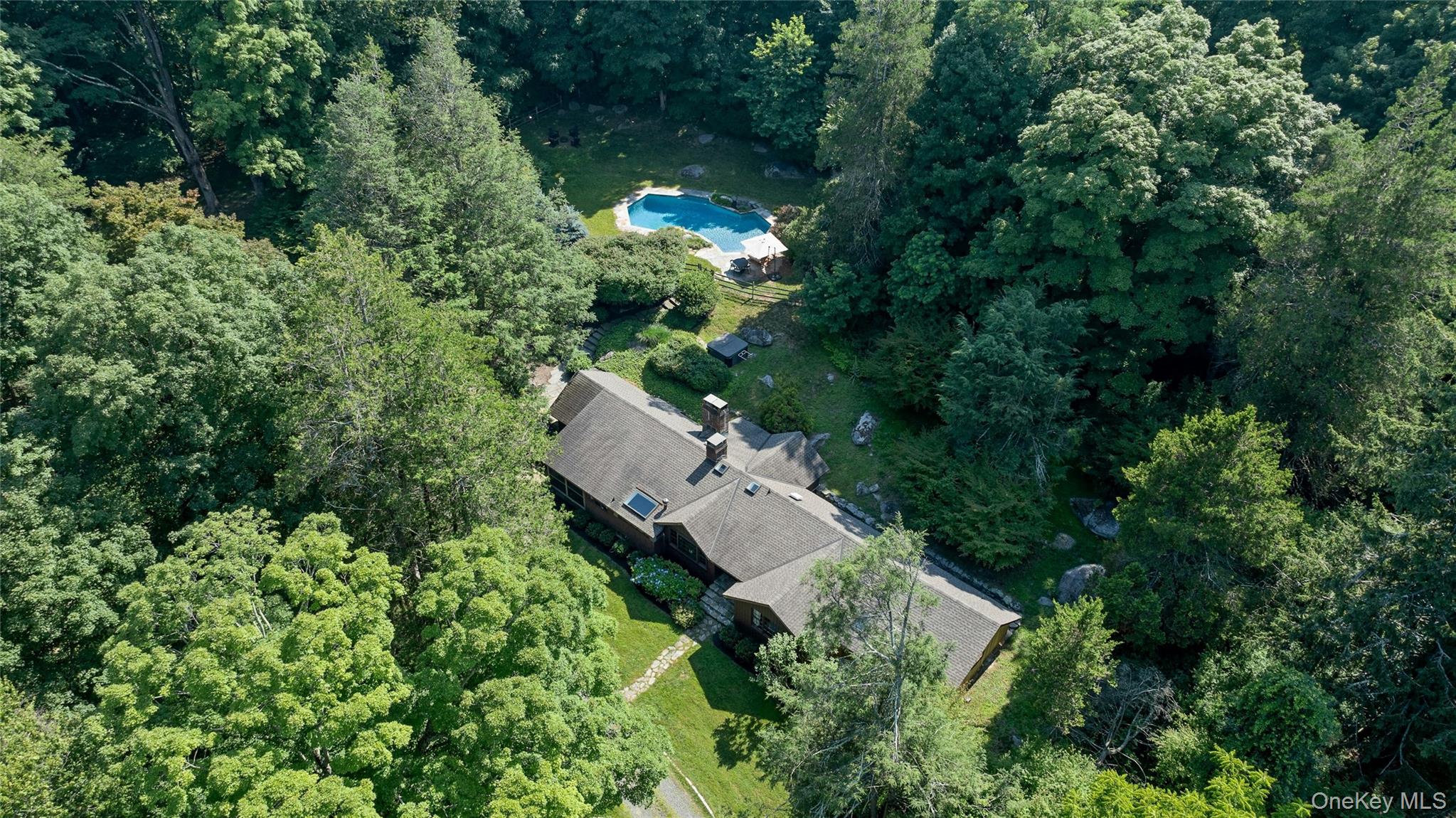Set on more than 7 private acres, this distinctive woodland retreat of...