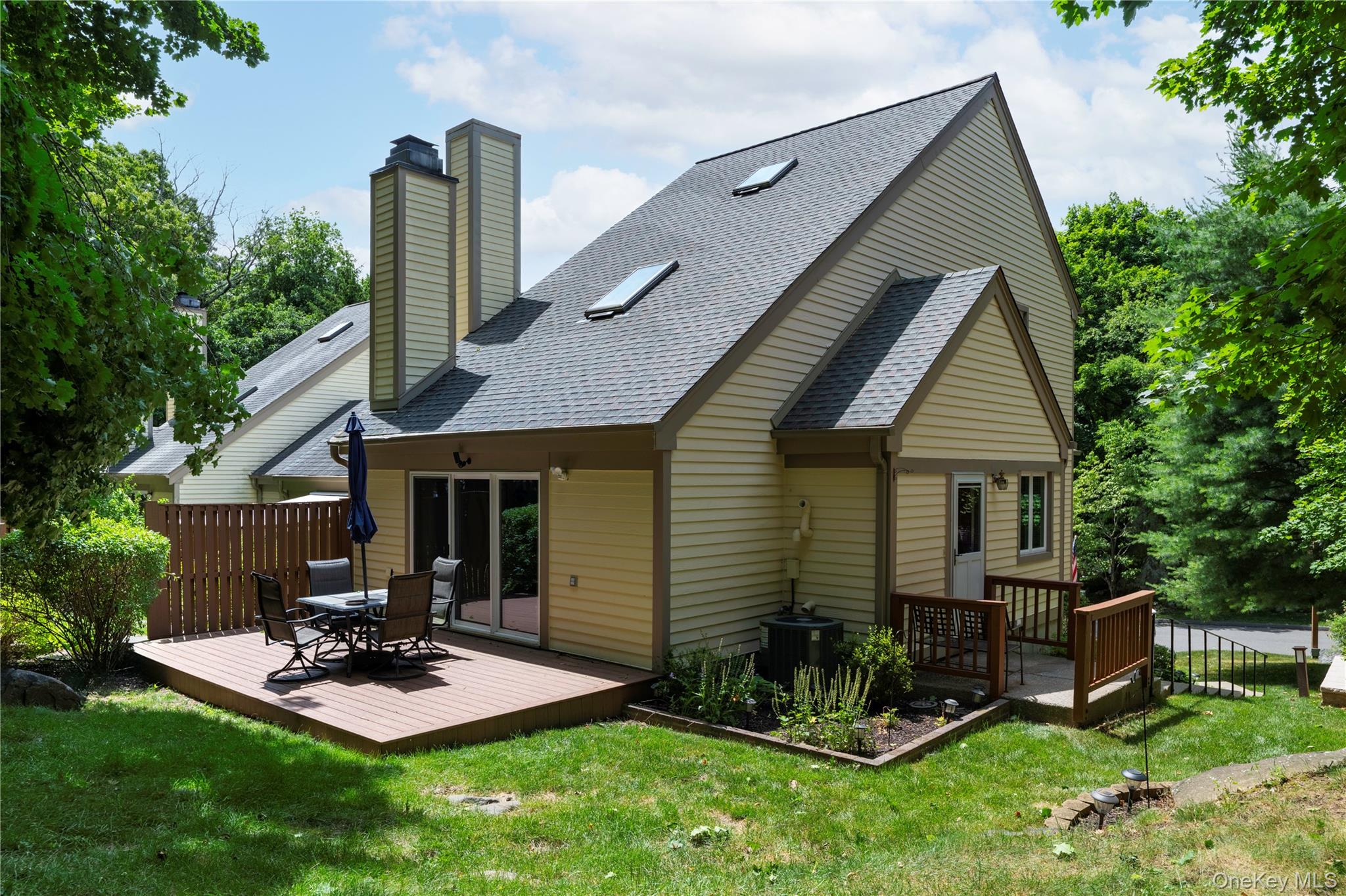 Privately set and beautifully maintained three-level end-unit townhous...