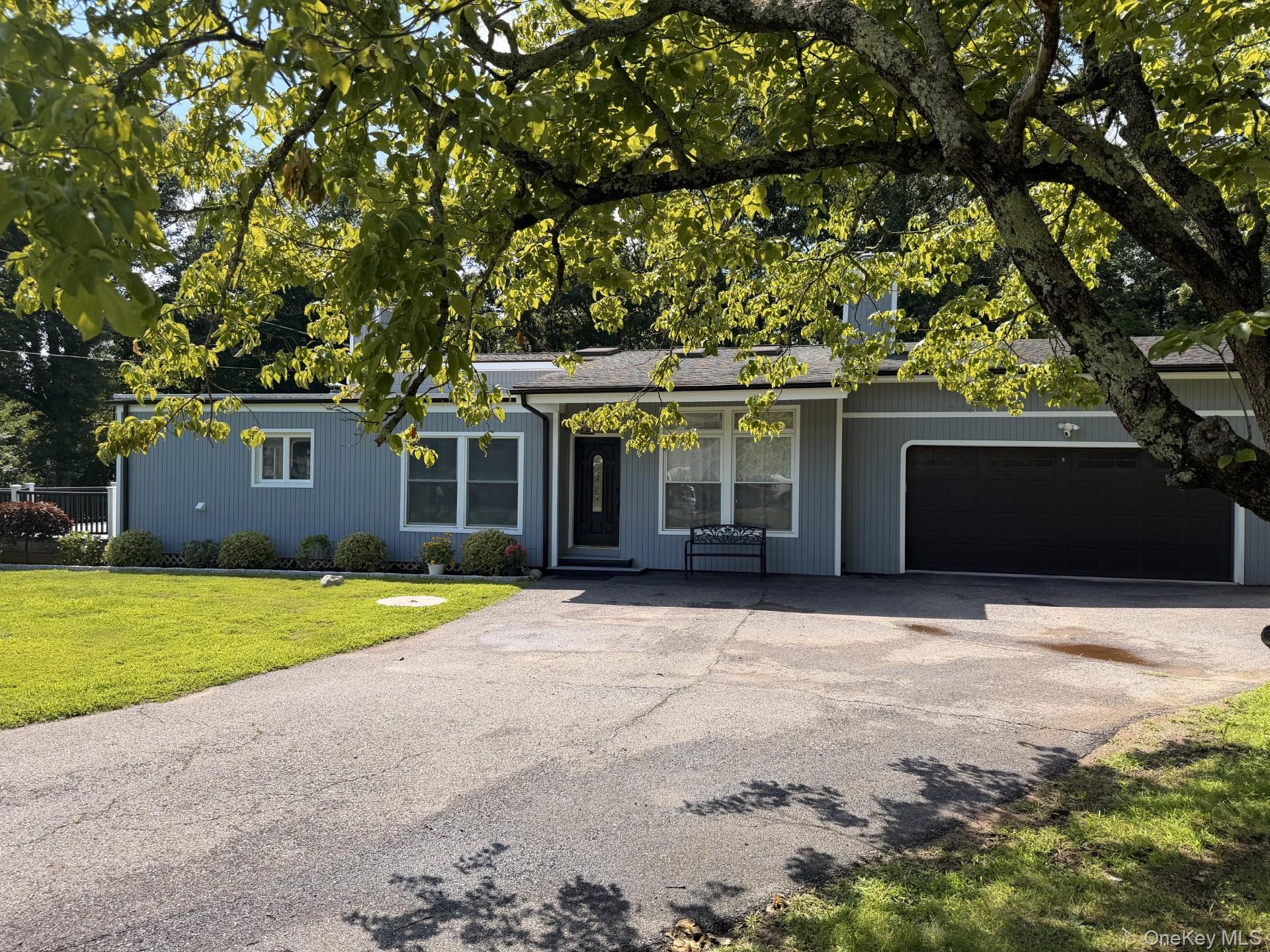 Nestled on a picture perfect landscaped, park-like acre, this contempo...