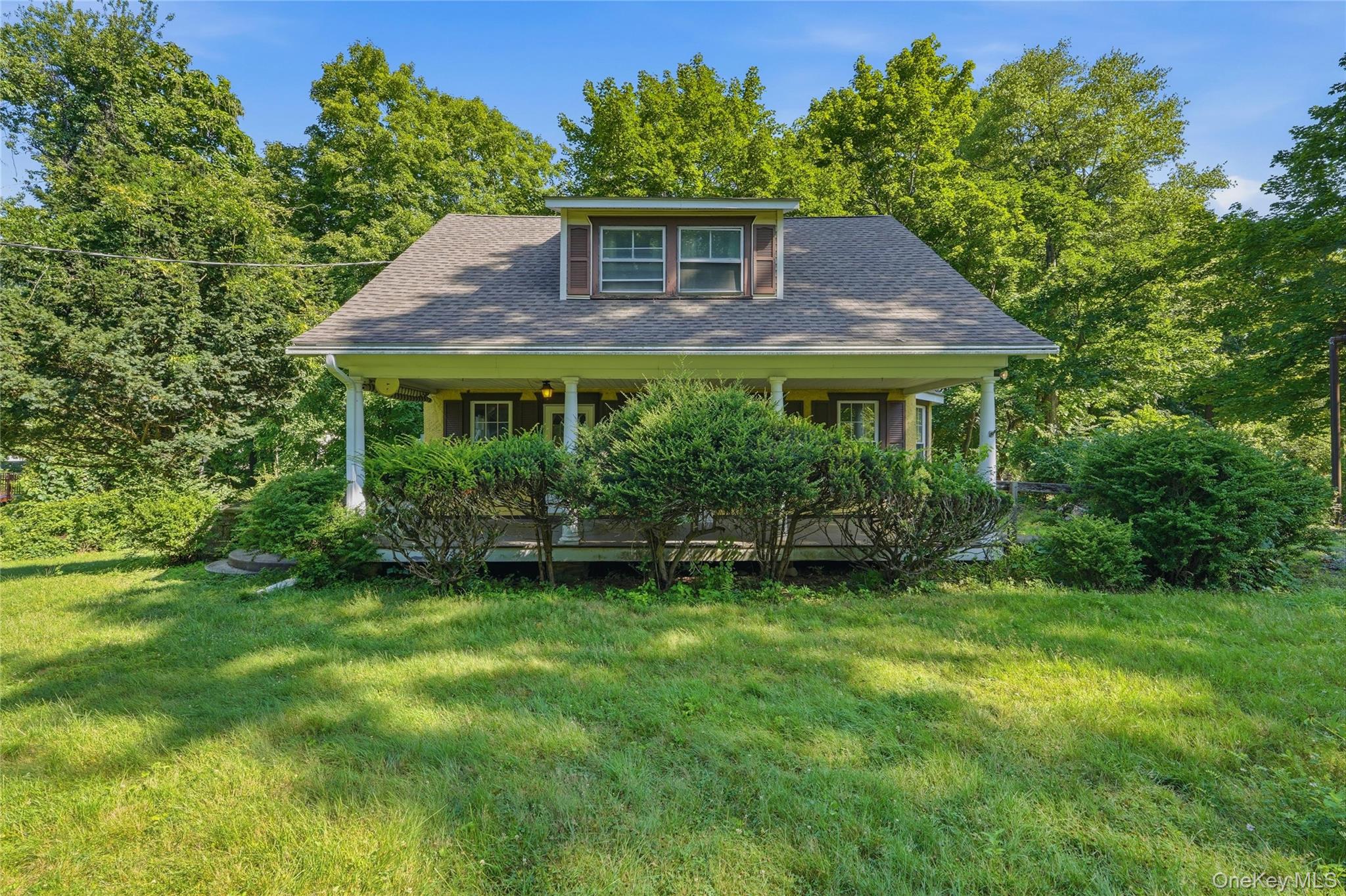 Charming 1920s stucco Cape Cod nestled on .51 acres in a peaceful Mohe...