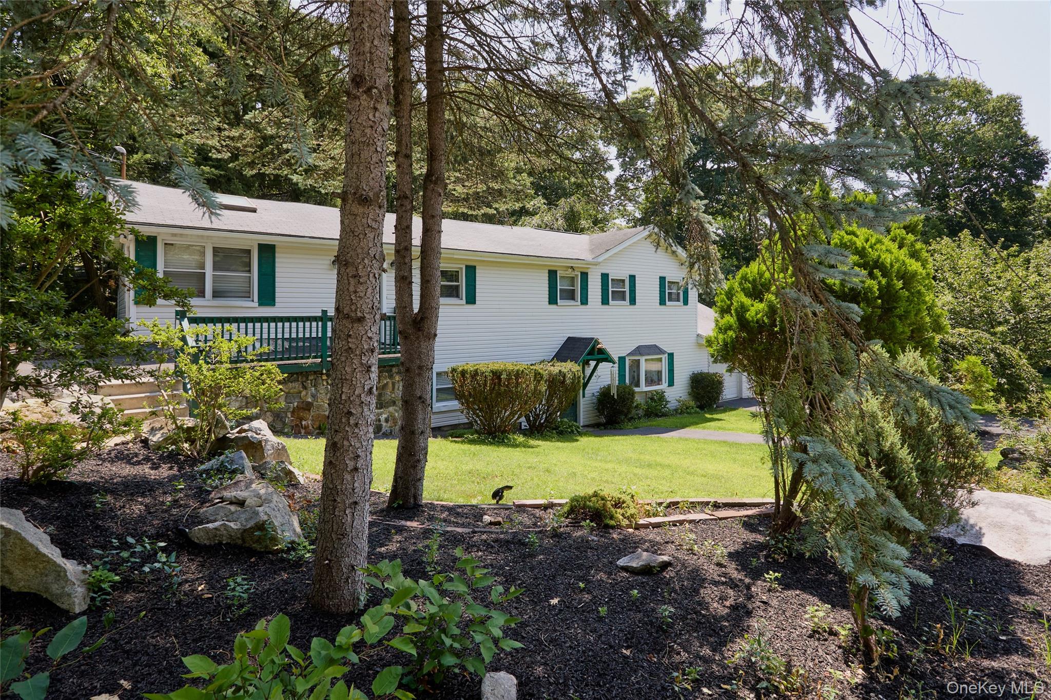 Set on a quiet road in the Lake Peekskill community, 140 Nardin Road i...