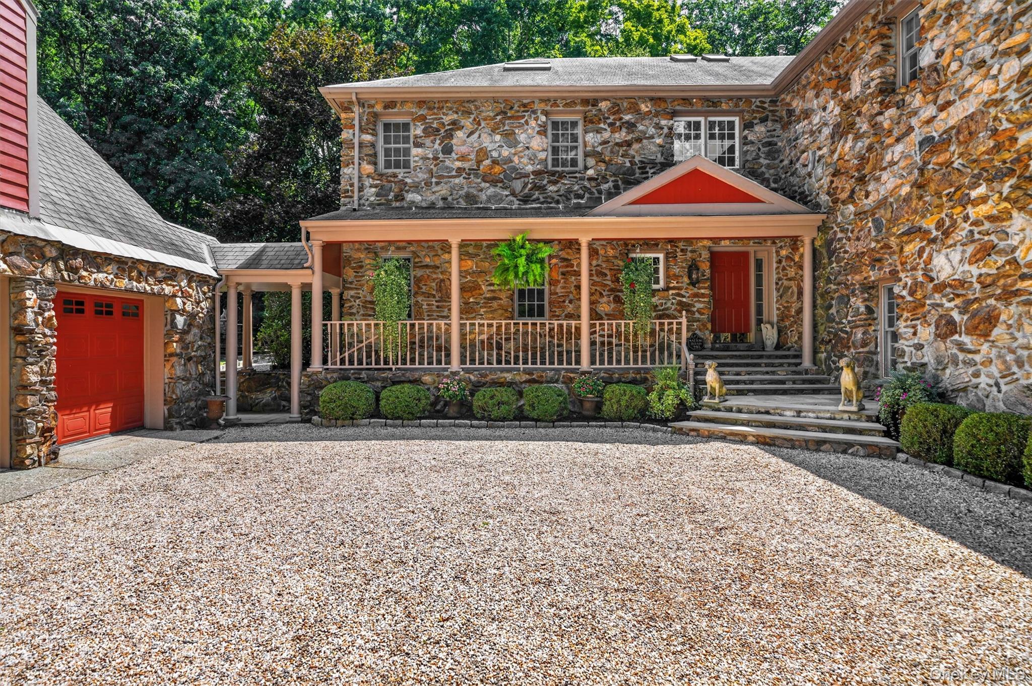 Set behind stone pillars at the end of a meandering private drive, thi...