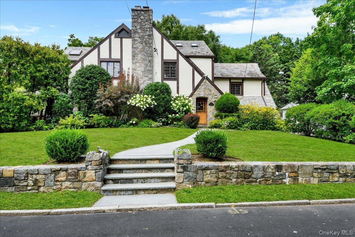 Rare opportunity to own an impressive 5-bedroom, 4-bath Tudor with ove...