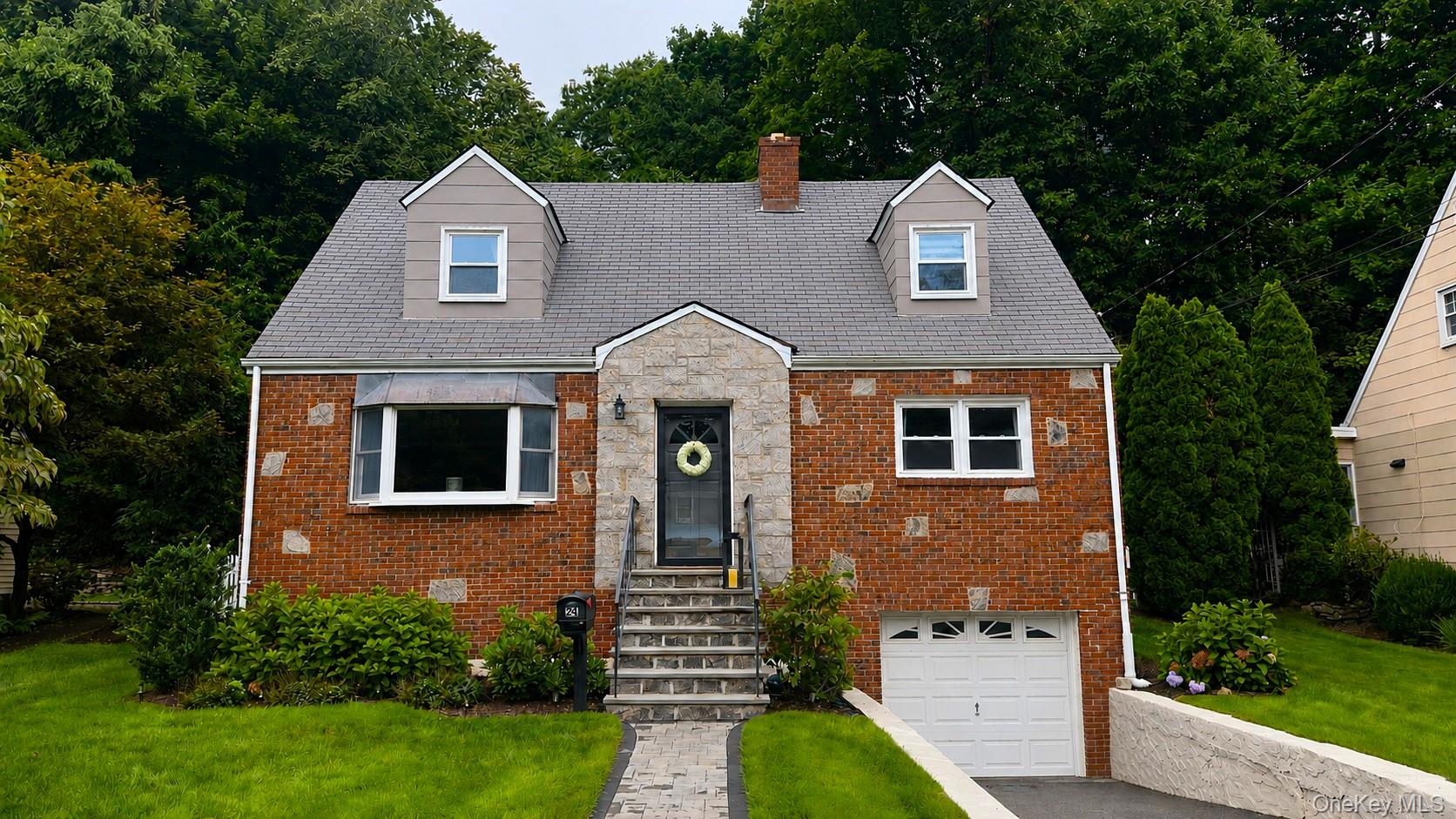 Charming, well-maintained 2-story brick & stone Cape on a level lot in...