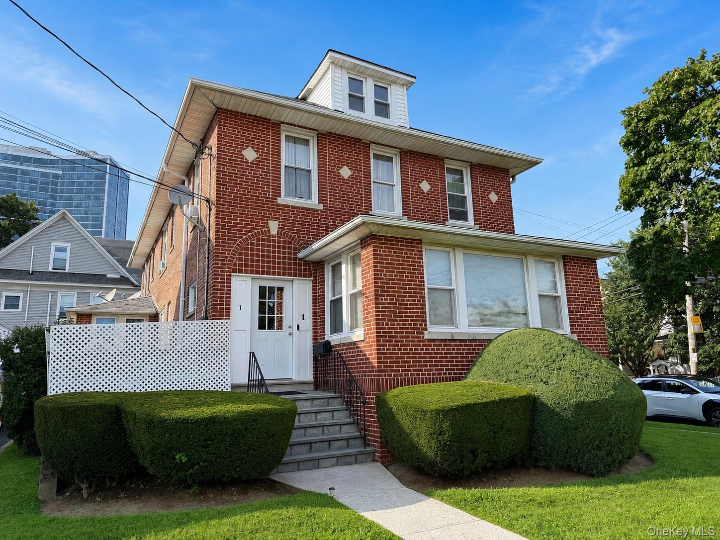 All-brick two-family on a corner lot, 1 Davis Avenue offers a layout b...