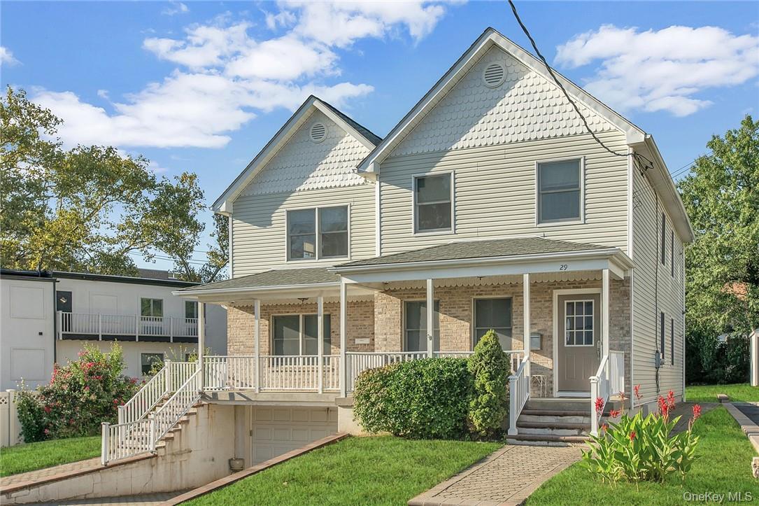 Enjoy your morning coffee from the charming front porch of this RENOVA...