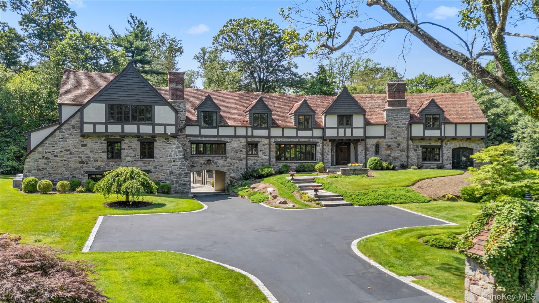 Set high on 2.08 serene, private acres within the prestigious Westches...