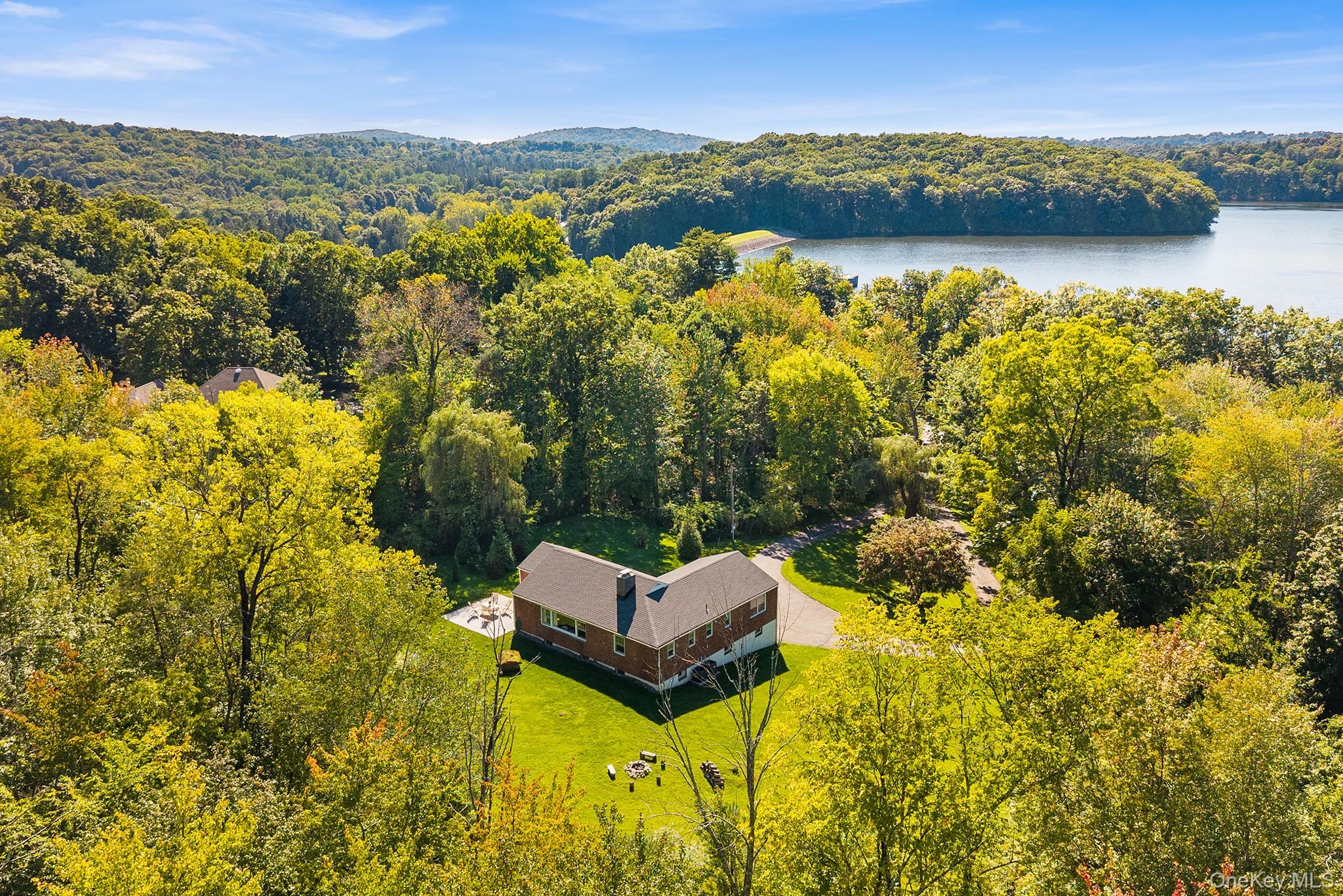 Tucked into a private woodland setting on more than 3 acres with seaso...