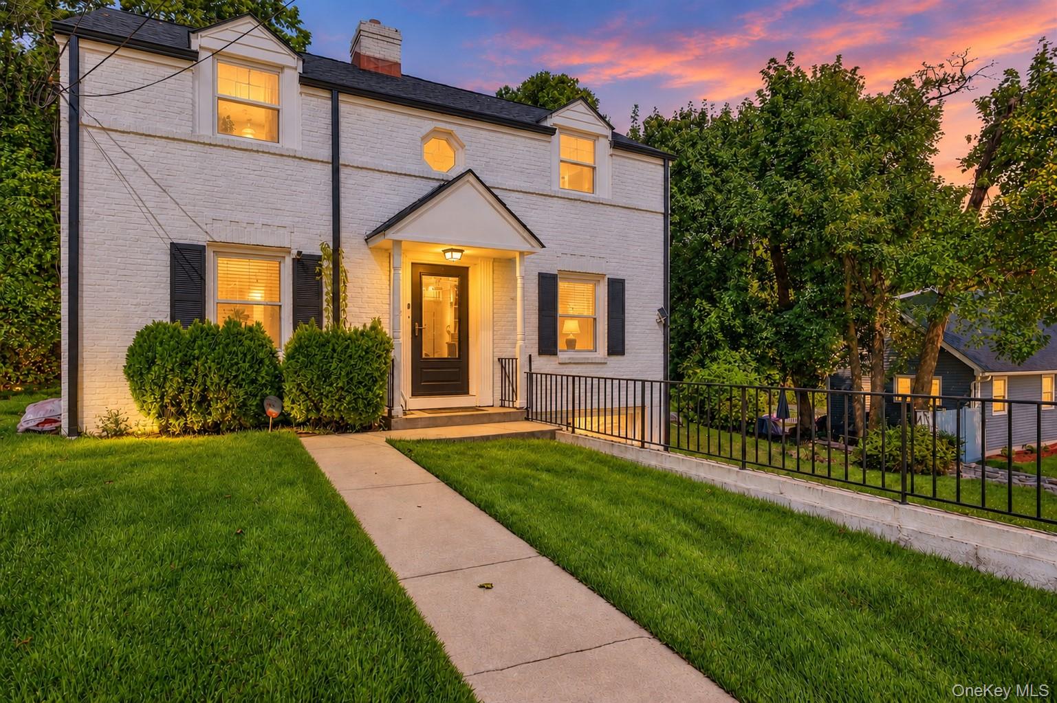 Behind its white-washed brick facade a Colonial with character, presen...