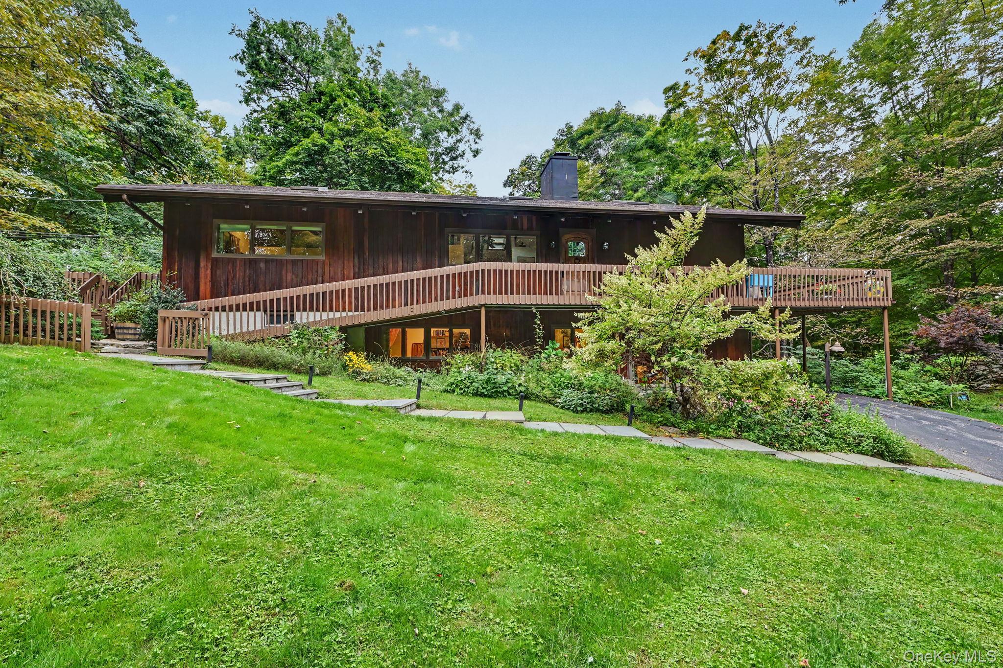 Tucked away on two private acres, this distinctive mid-century modern...