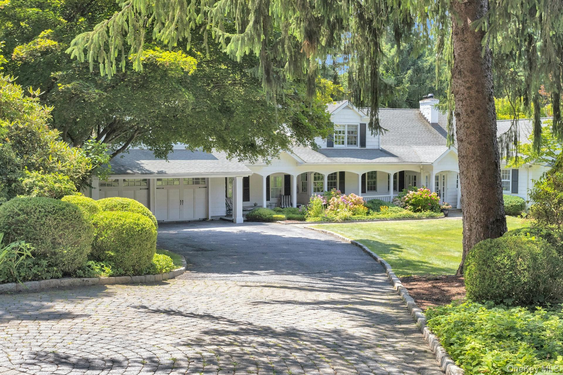 Welcome home to this charming farmhouse, privately set back on just un...