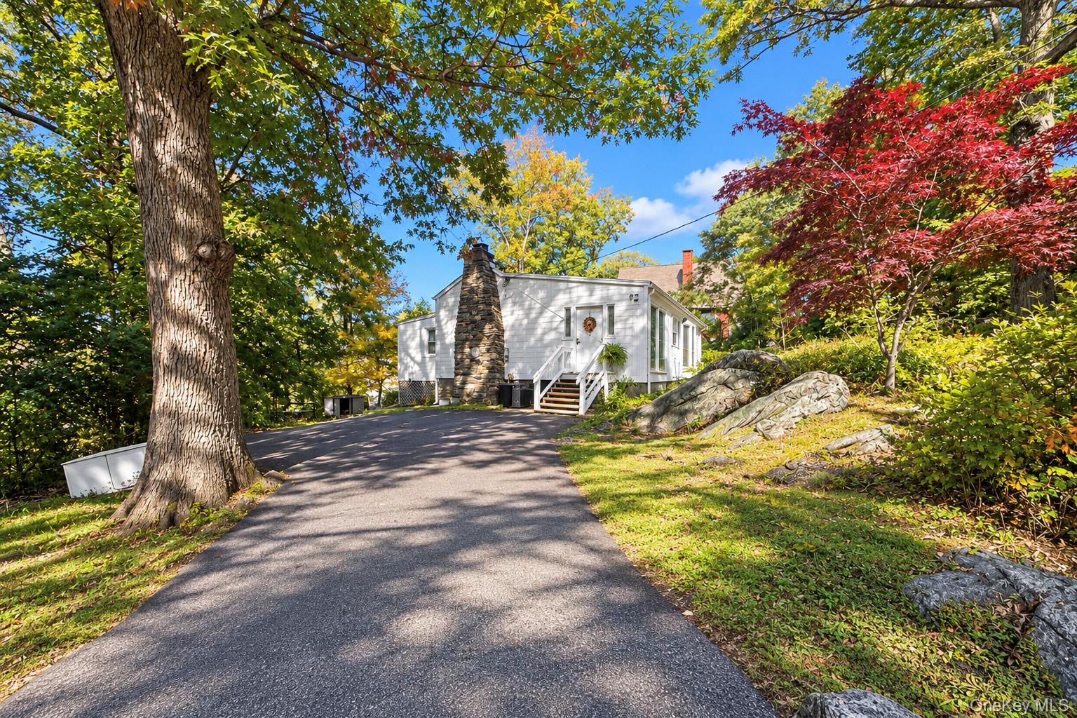 Tucked away on a tranquil, tree-lined corner lot in North White Plains...