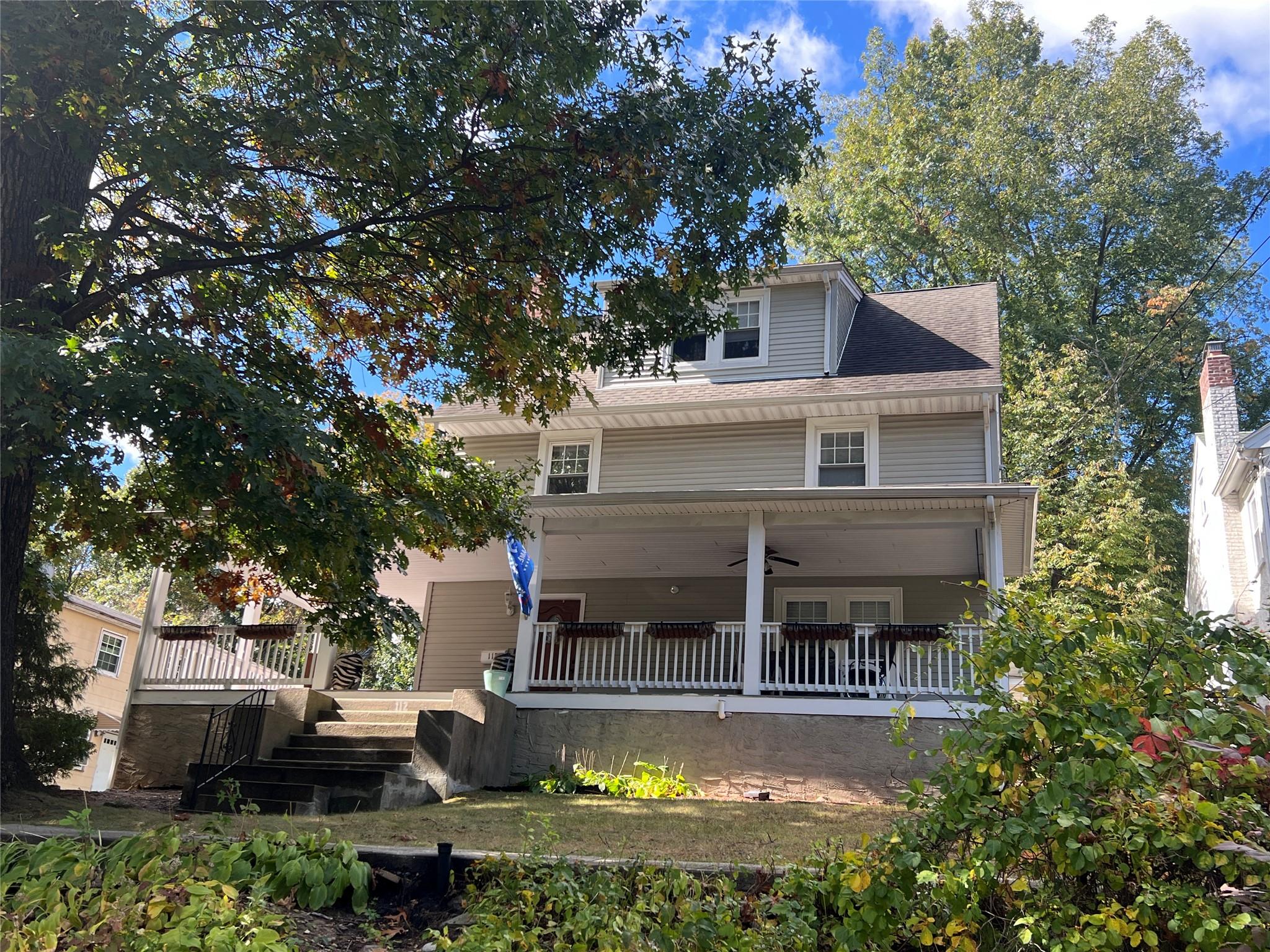 The hallmarks of this vintage home include a welcoming rocking chair p...