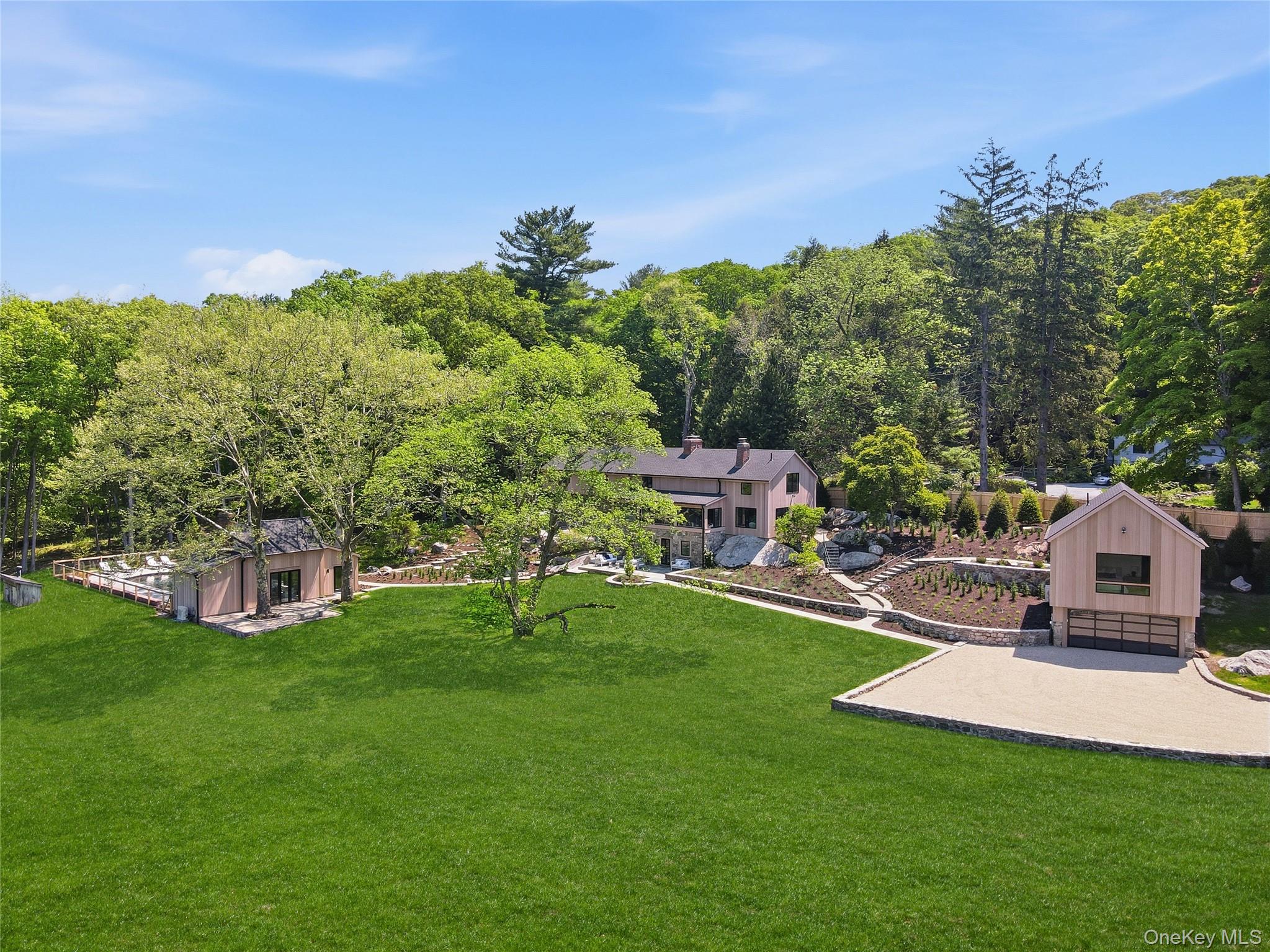 Behind private gates, nearly six acres of bucolic countryside unfold a...