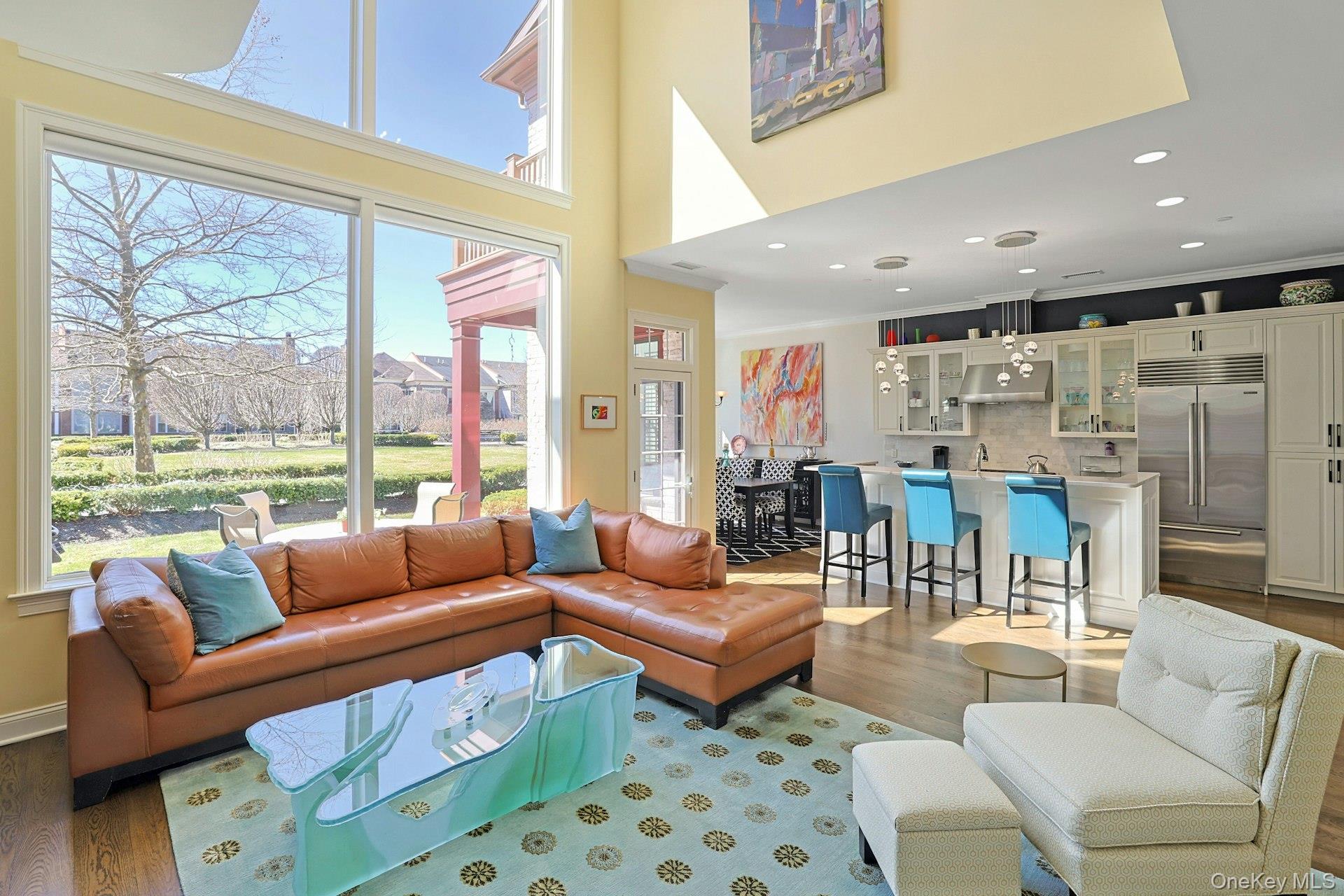 Open & Bright Living with dramatic double height wall of windows. Rare...