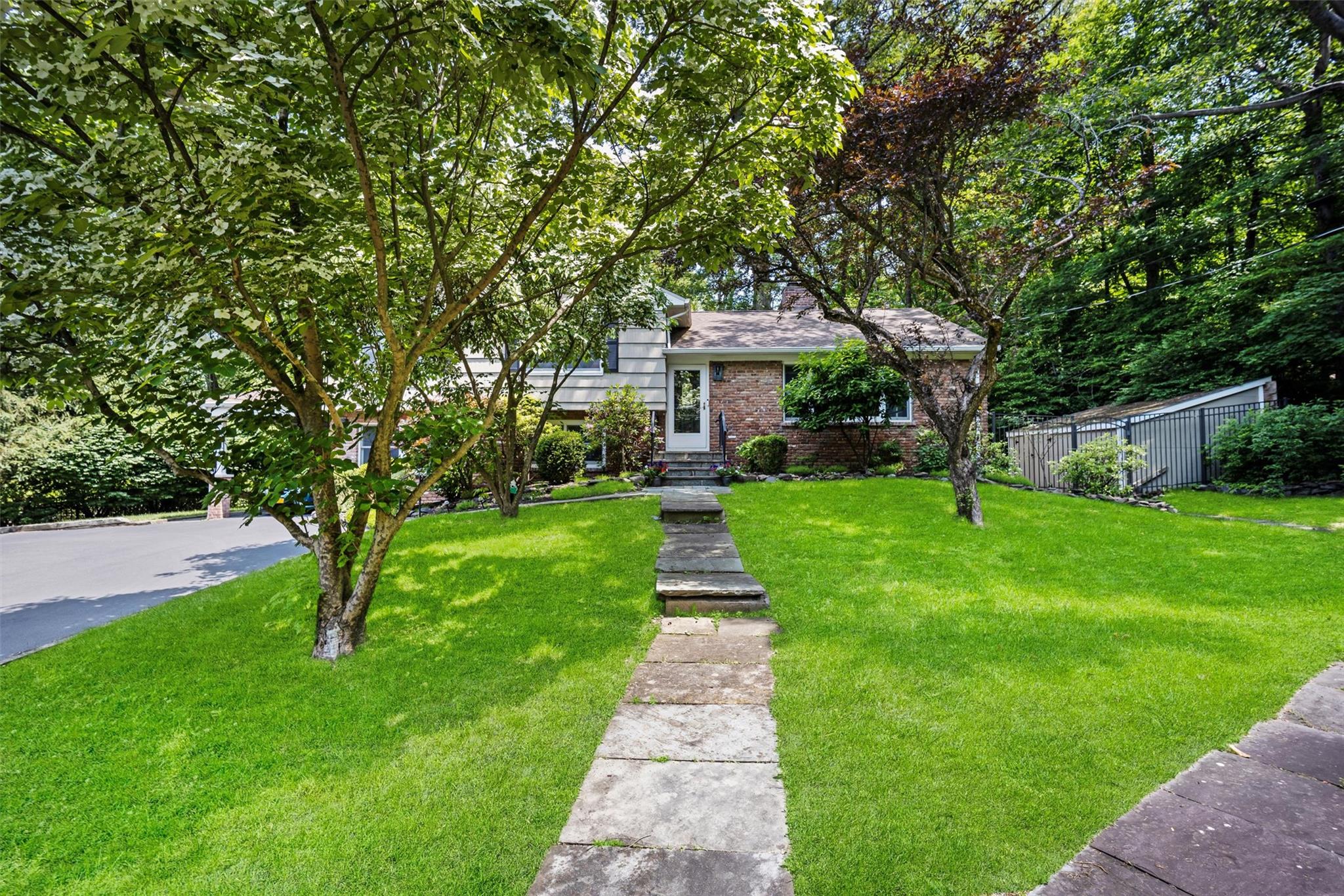 Nestled on a picturesque 1.4 acre lot in a serene wooded Croton Villag...