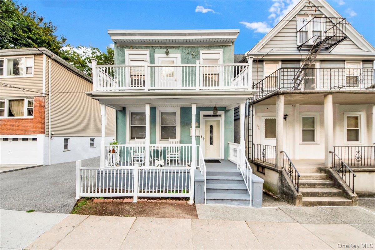 Charming two-family home in East Yonkers with classic rocking chair fr...