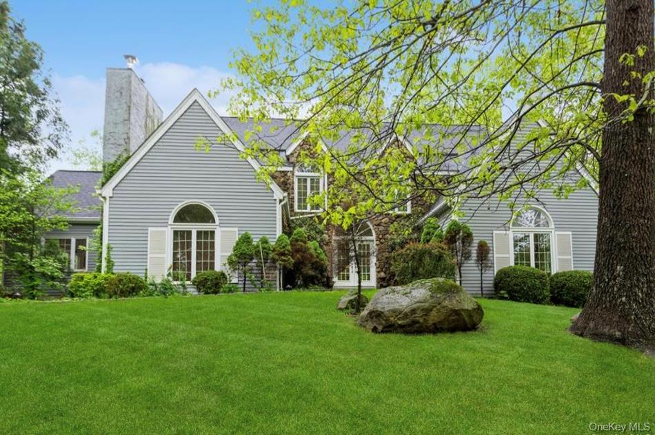 Elegantly updated Modern Colonial with majestic curb appeal on a quiet...