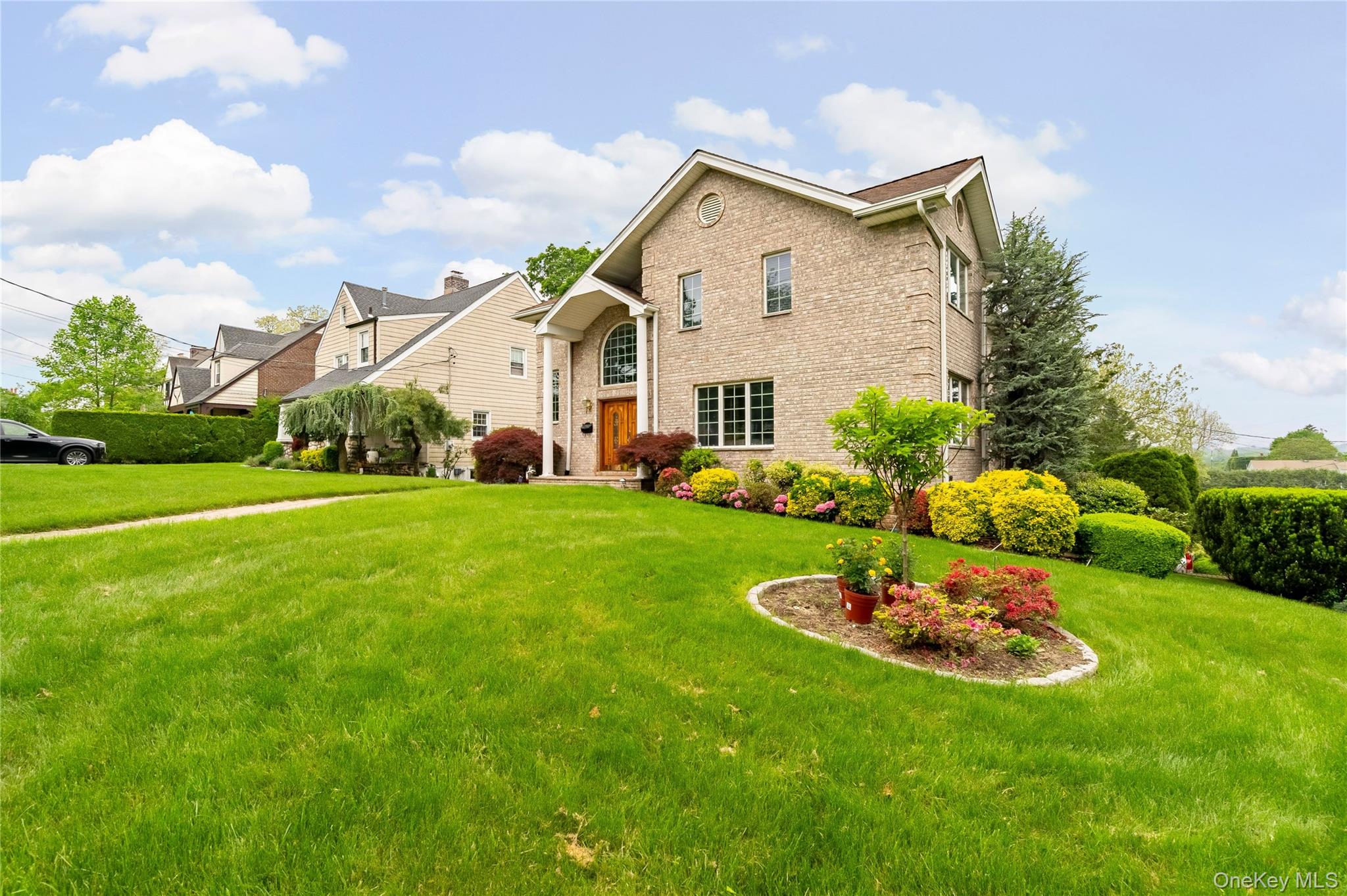 This elegant full-brick colonial sits on a prominent corner lot and we...