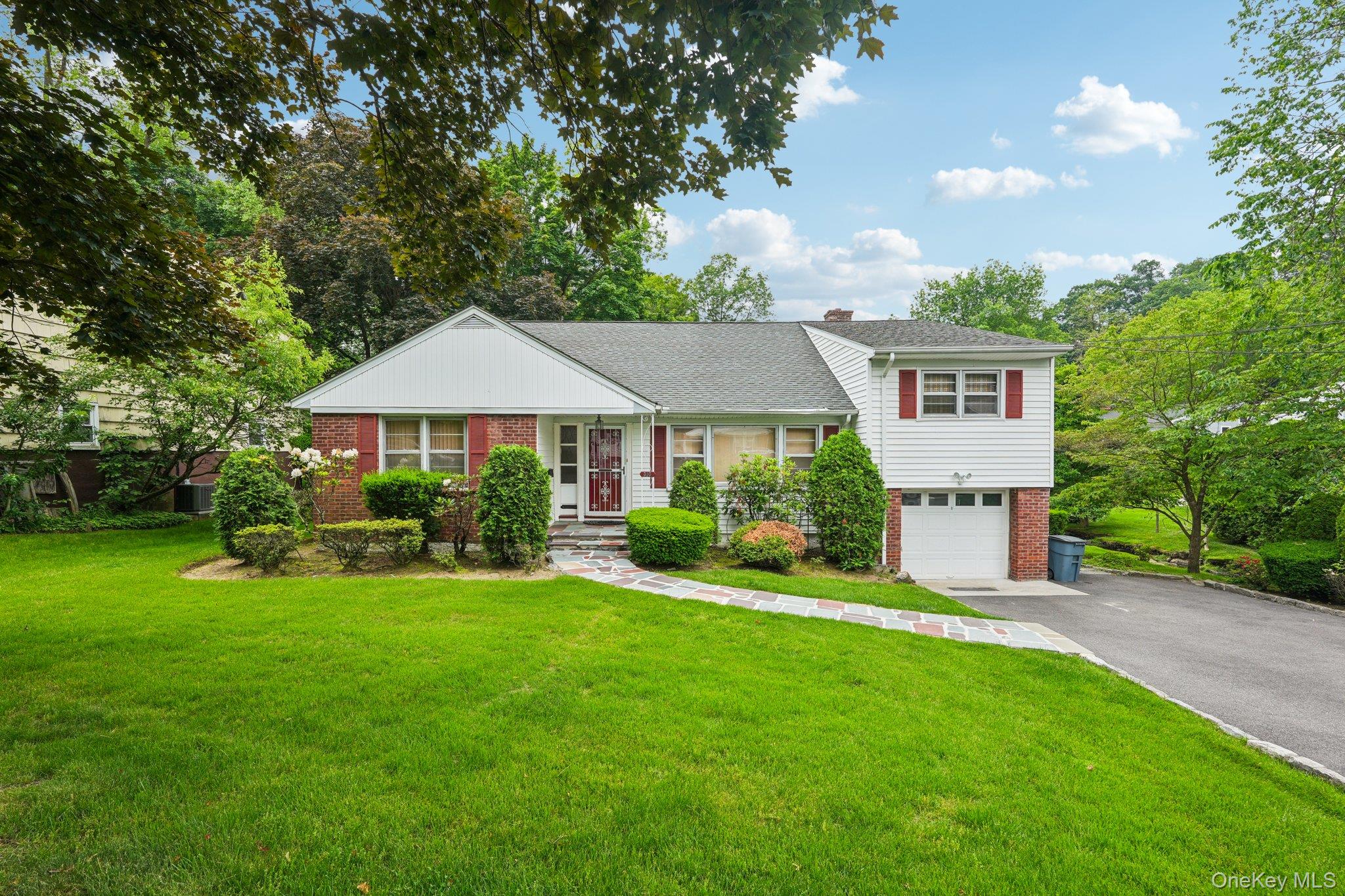 Discover this delightful split-level home situated on a tranquil, tree...