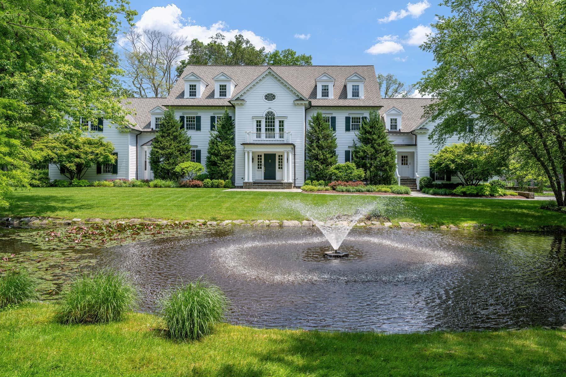 Privately nestled behind gates on 2.89 lush acres, this classically up...