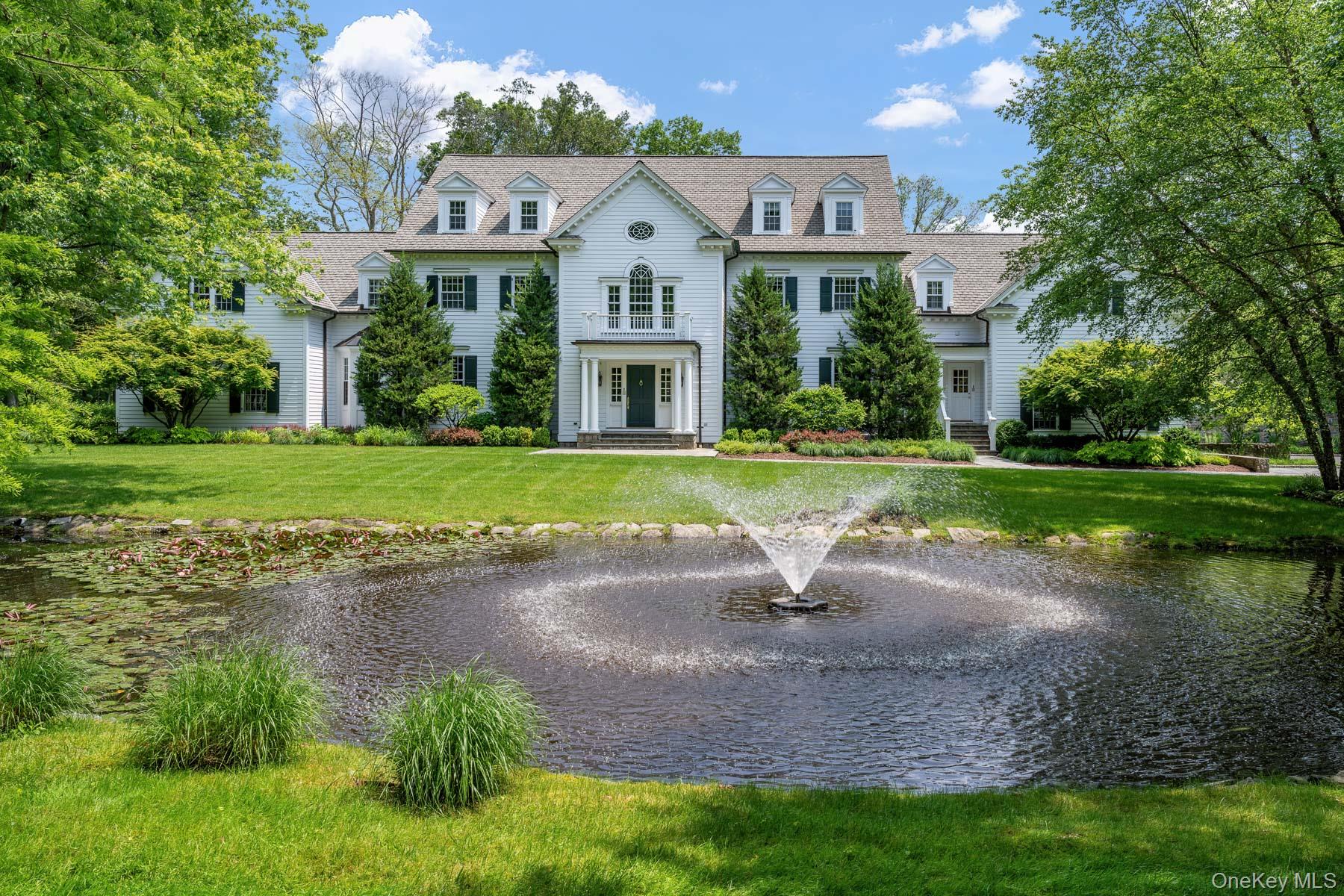 Privately nestled behind gates on 2.89 lush acres, this classically up...