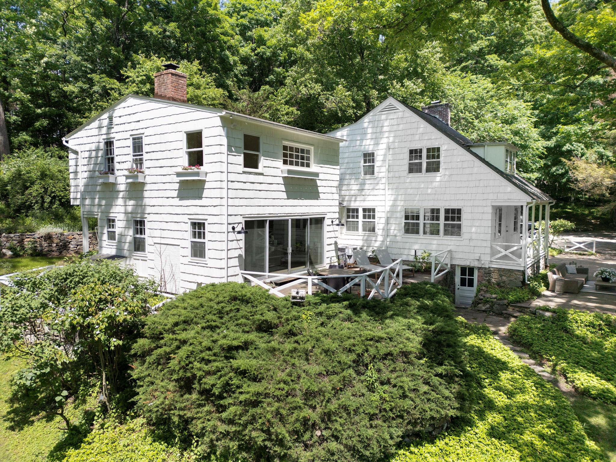 Tucked away in a 3+ acre private storybook setting, this reimagined fa...