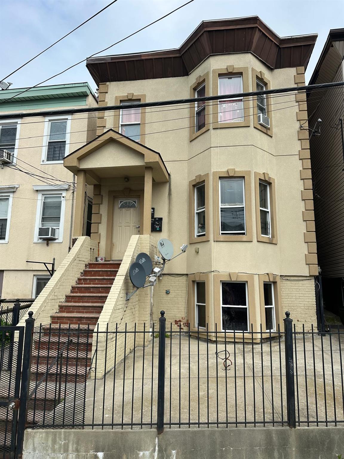 Welcome to this charming three-family residence located in the heart o...