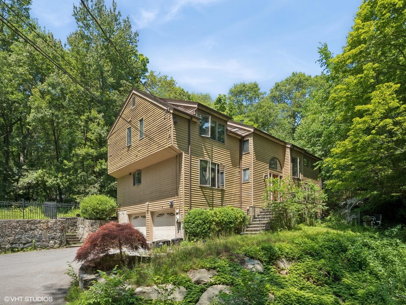 Tucked away on a quiet, wooded lane, this contemporary retreat is all...