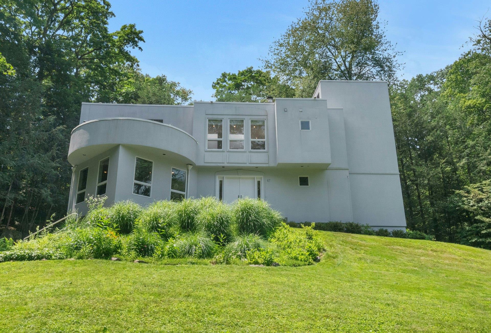 This sleek contemporary is located in the heart of Katonah within walk...