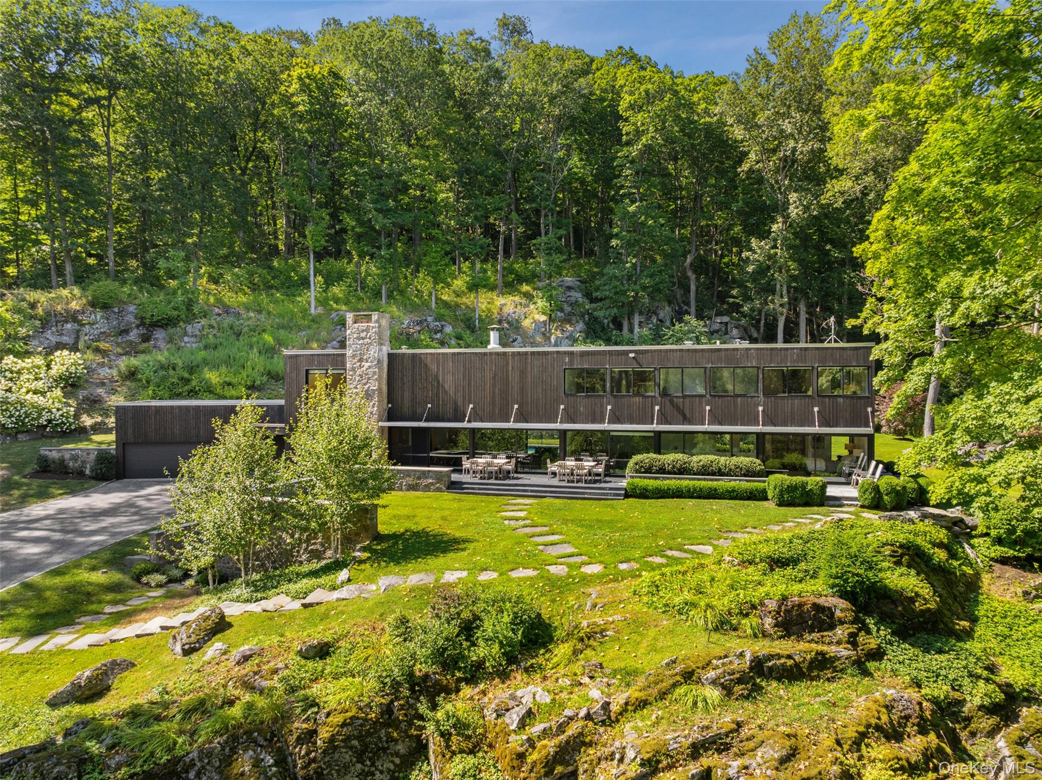 Experience modern design in perfect harmony with nature at 147 Mianus...