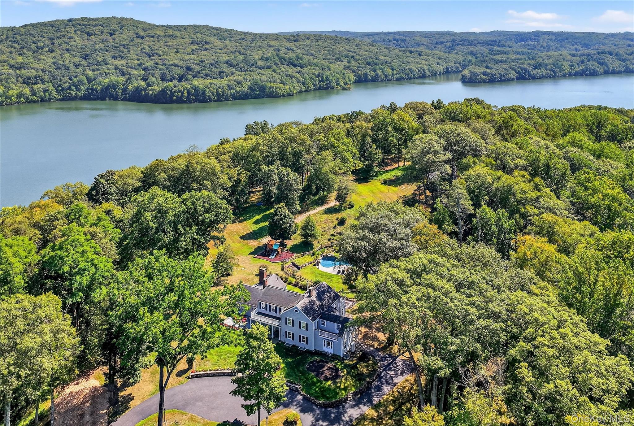 Nestled on over 10 acres that extend gracefully into the reservoir, th...