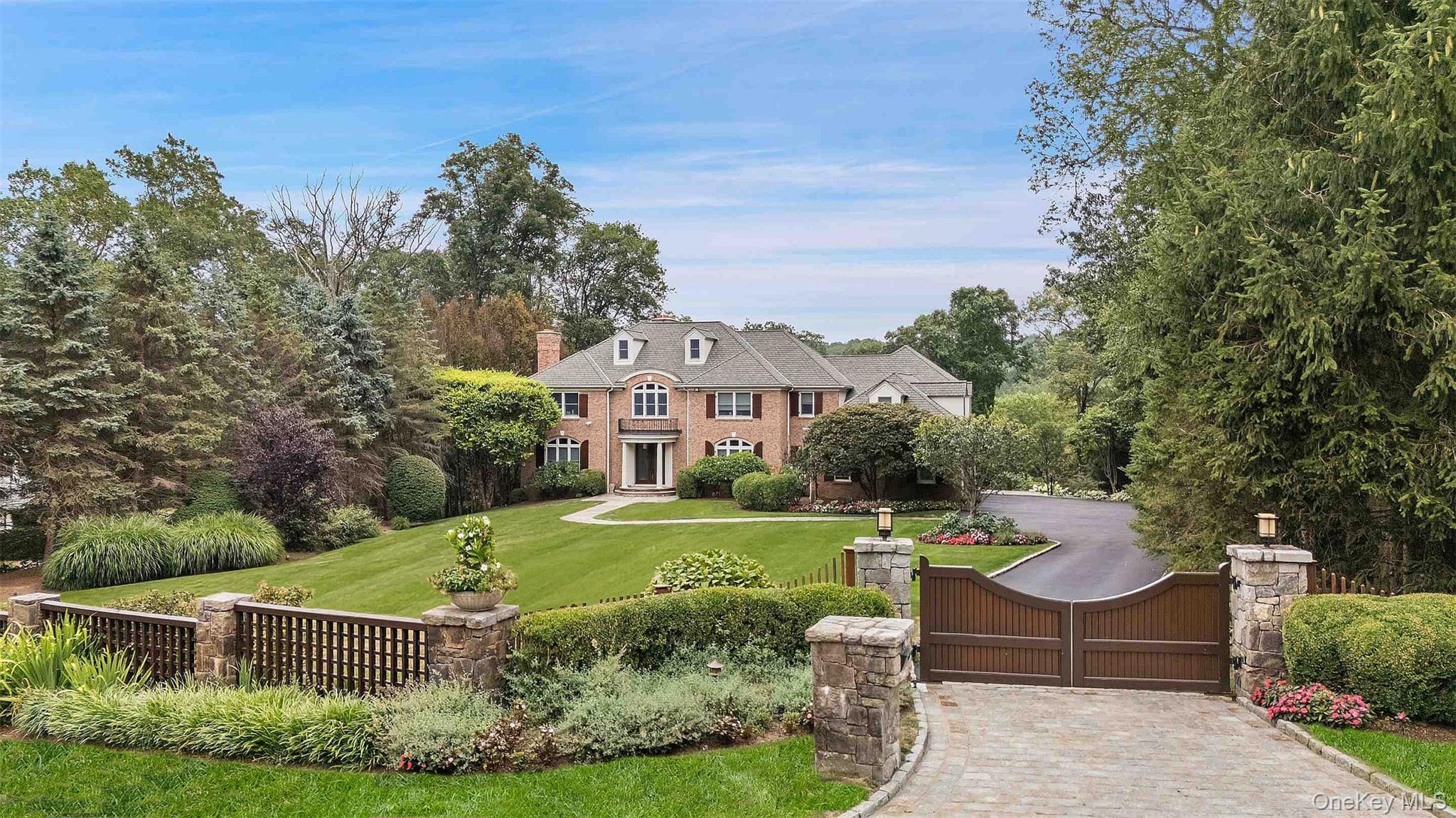 Gracious Brick Georgian Colonial, nestled on 2 resort-like acres with...