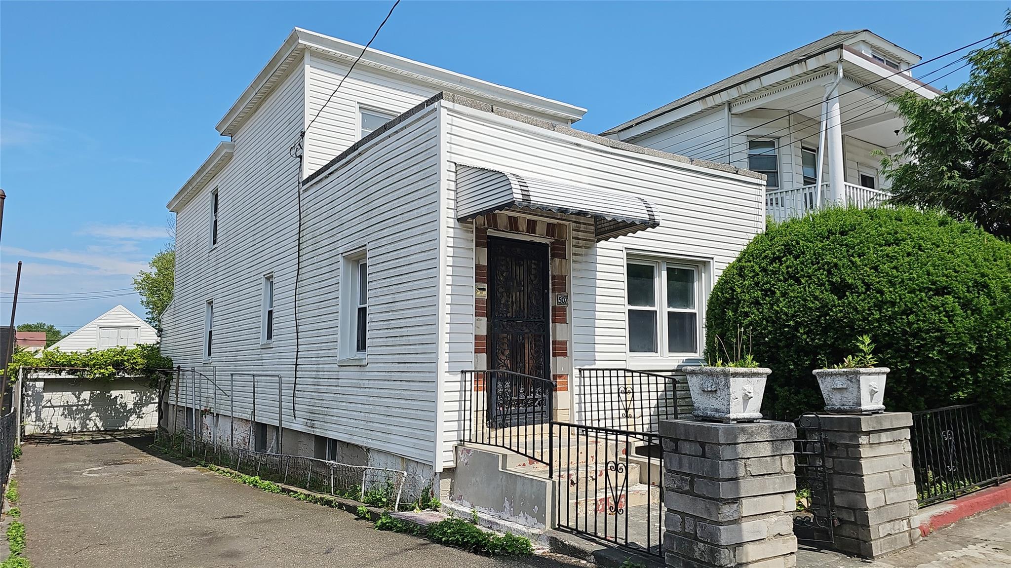 Larger legal two-family dwelling with 2 car garage and sweet back yard...