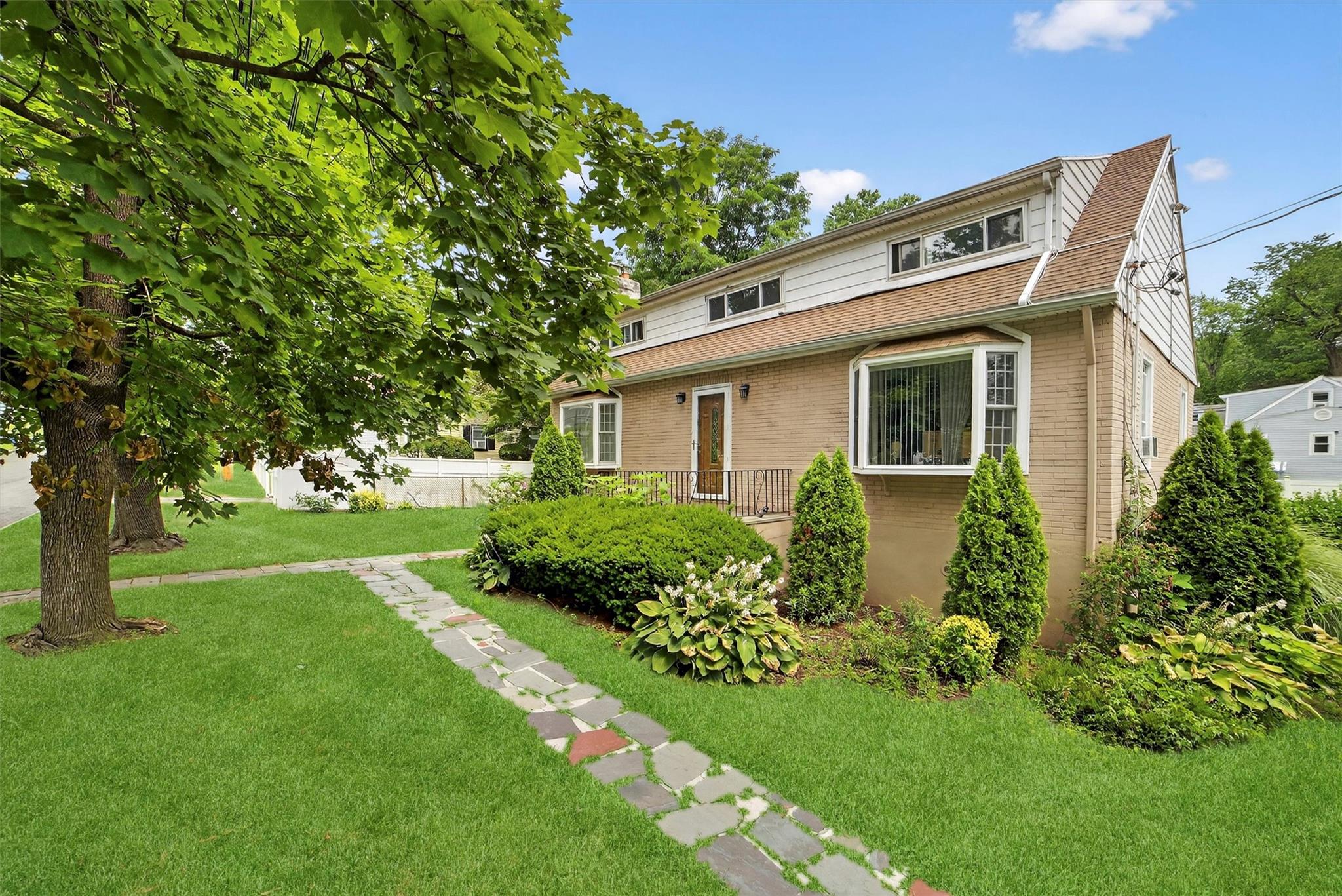 Discover this well-maintained two-family brick colonial offering timel...