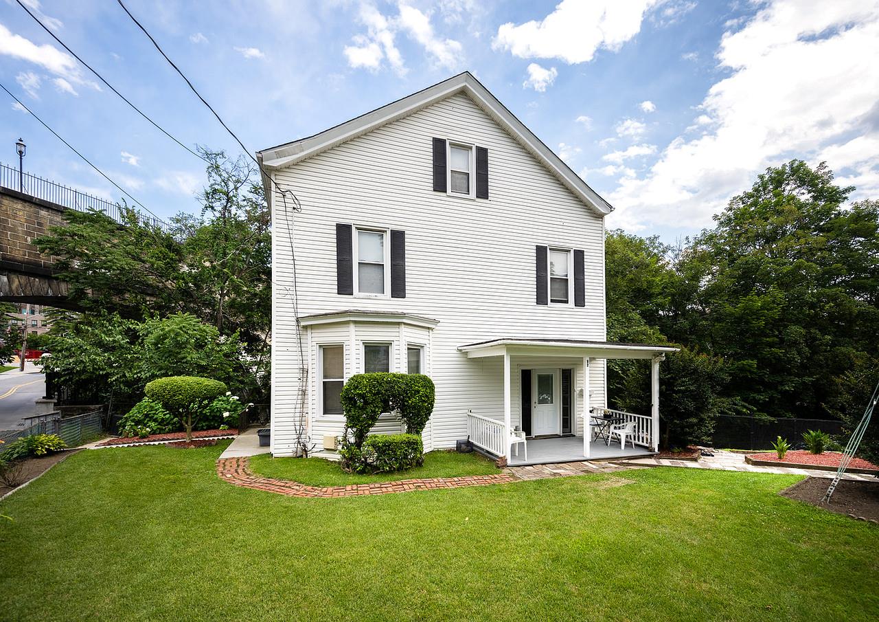 This Colonial TWO-FAMILY dwelling is located in the heart of the villa...